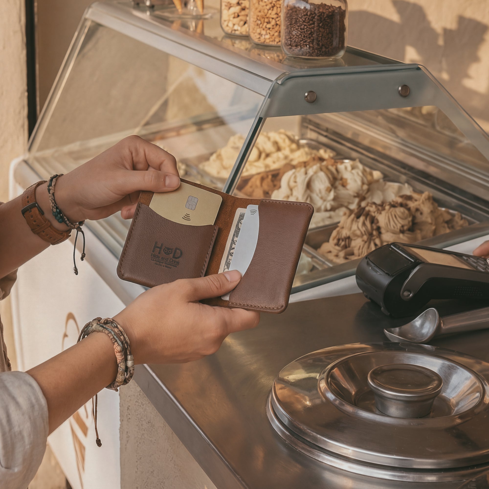 A hand holding Hide & Drink's Bifold Slim Card Holder, demonstrating its compact size and perfect fit for pocket storage. This minimalistic wallet is ideal for credit card storage and cash organization, offering a blend of style and function. Crafted with full grain leather, it's a stylish choice for anyone looking for a durable money organizer crafted in La Antigua Guatemala.