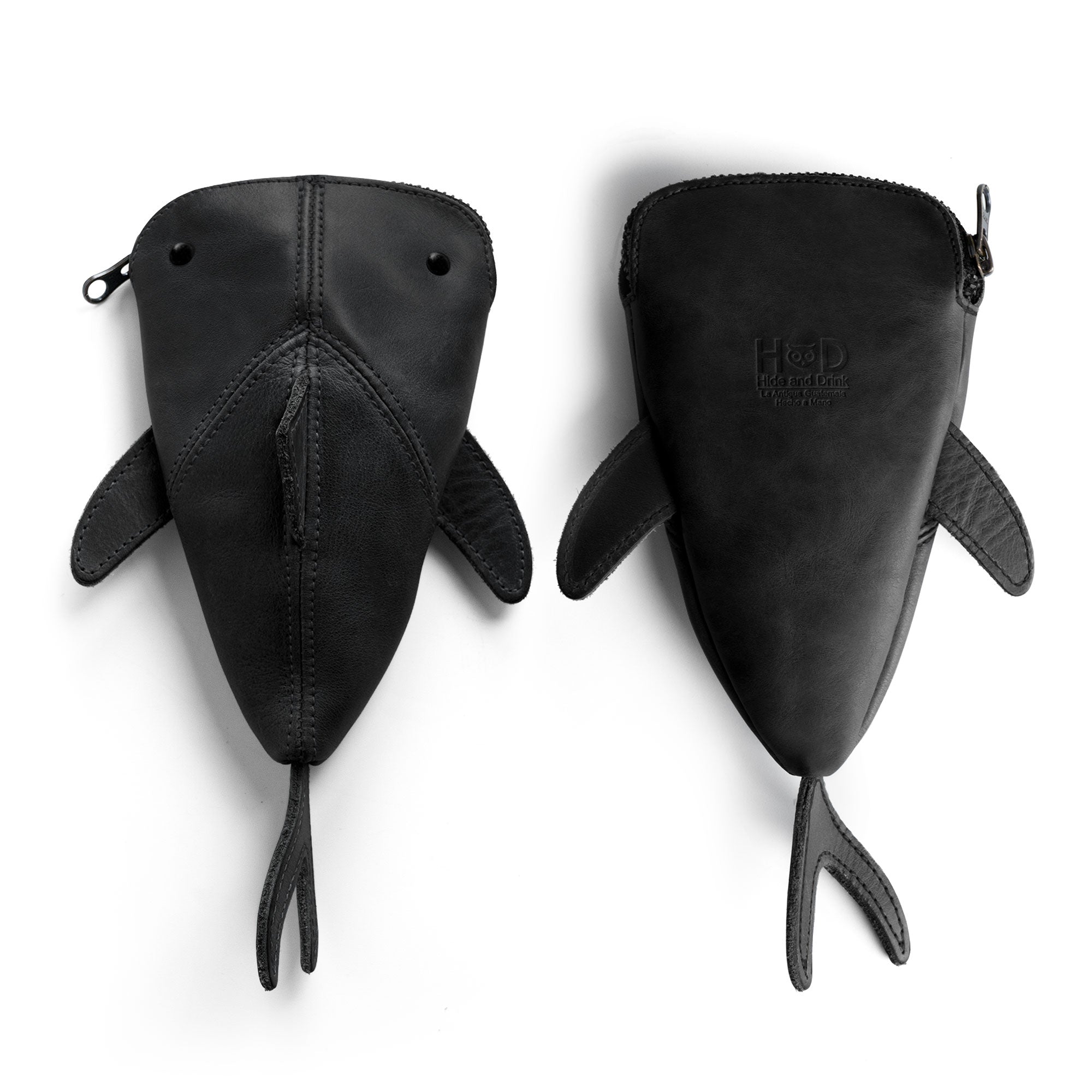 Side view of the unique Leather Shark Pouch by Hide & Drink, a palm-sized zippered coin pouch. This shark shaped case features fine craftsmanship with full grain leather, making it a perfect pencil purse or change bag. Handmade in La Antigua Guatemala & Oaxaca Mexico, this artisan product combines small batch production with a charming design.