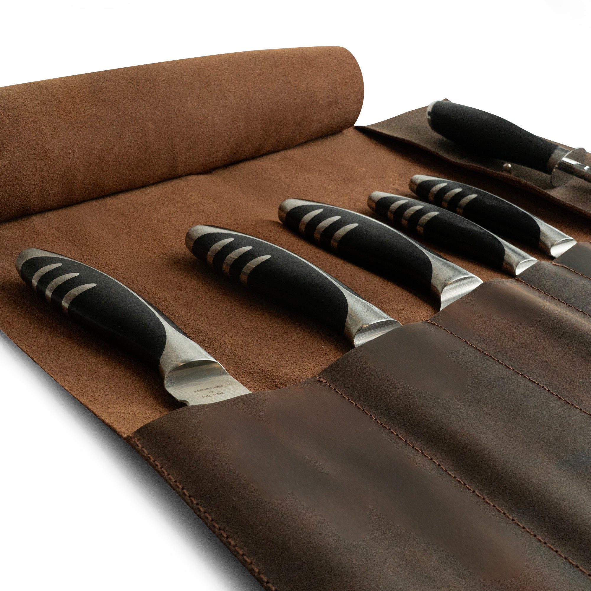Hide & Drink Knife Roll (5 Pockets) featuring an elegant design in Full Grain Leather for the culinary enthusiast. A practical Chef Knife Bag that acts as a portable carrying case for knives, embodying artisan craftsmanship with small batch production methods, hand cut, and hand sewn details.