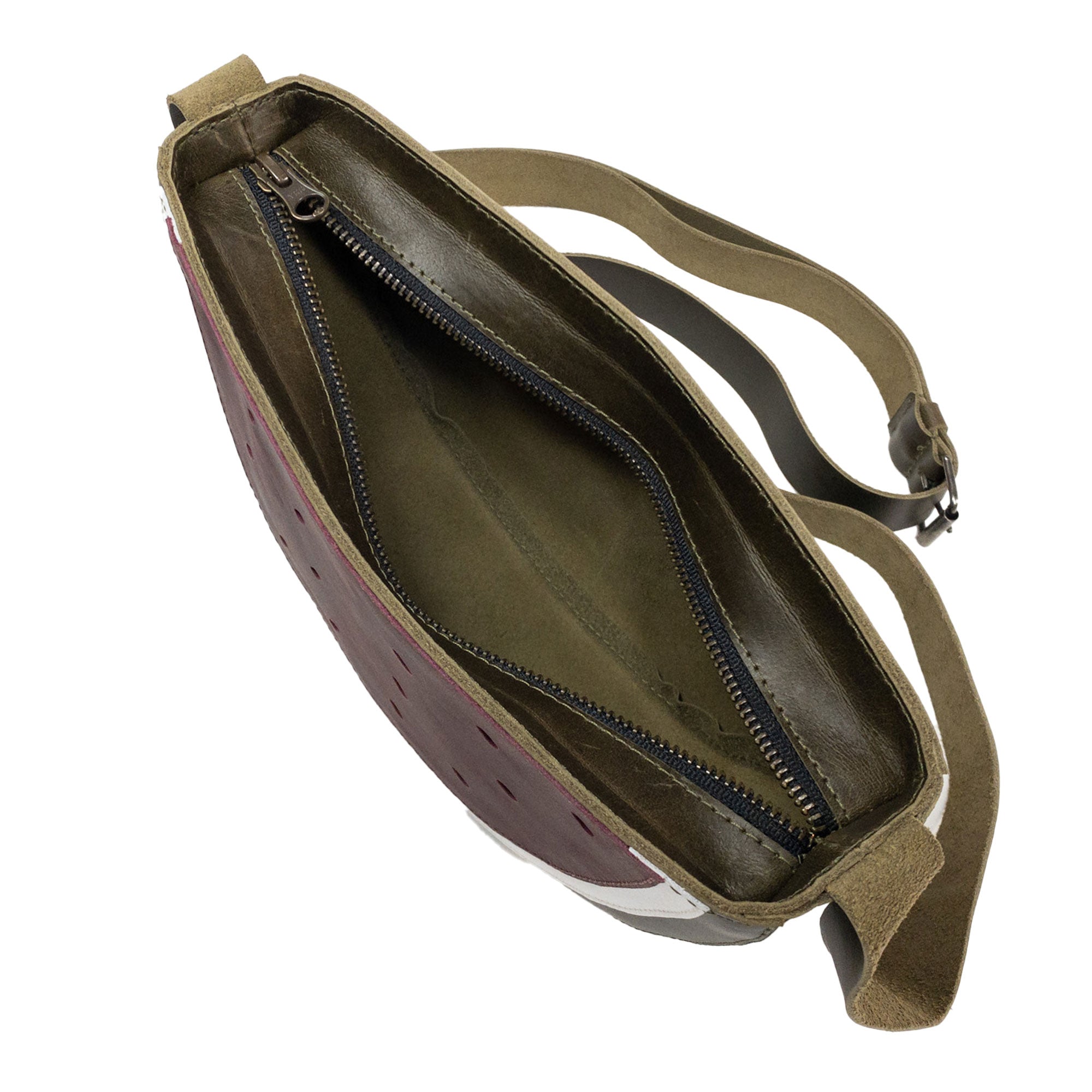 Inside view of the Watermelon-Shaped Shoulder Bag by Tudi Frudi, highlighting the expertly crafted compartments. This functional Crossbody Bag doubles as a Messenger Bag, made from Full Grain Leather, illustrating artisan skills through small batch production, hand cut, hand sewn, and fire branded methods. Handmade in La Antigua Guatemala & Oaxaca Mexico.