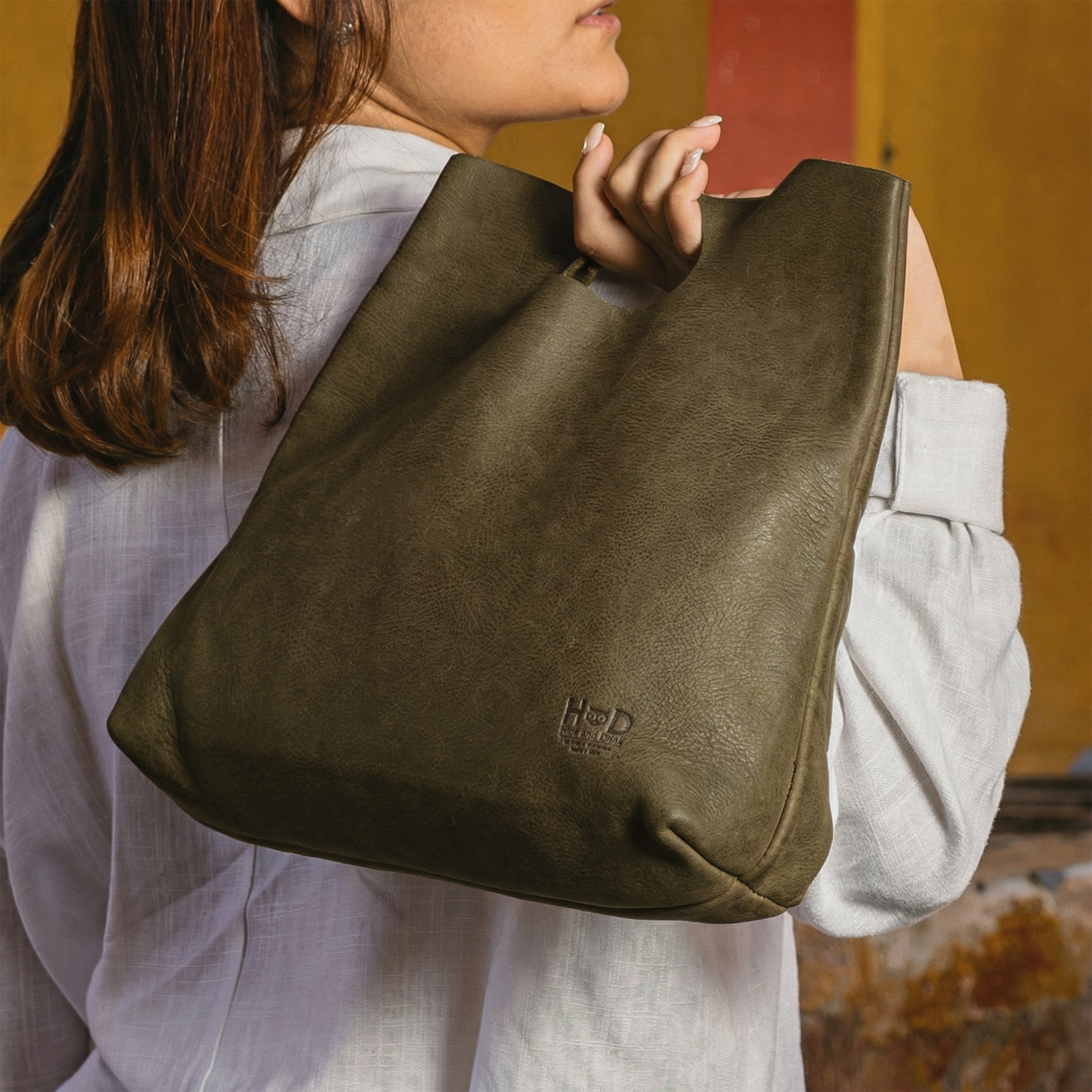 An overhead shot of the Minimalist Boho Handbag by Hide & Drink filled with everyday essentials. This Minimalist Handbag for Women serves as a practical Tote Bag, made from rustic Full Grain Leather, reflecting StockyardX’s commitment to artisan craftsmanship through Small Batch Production and Hand Cut techniques, made in La Antigua Guatemala & Oaxaca Mexico.