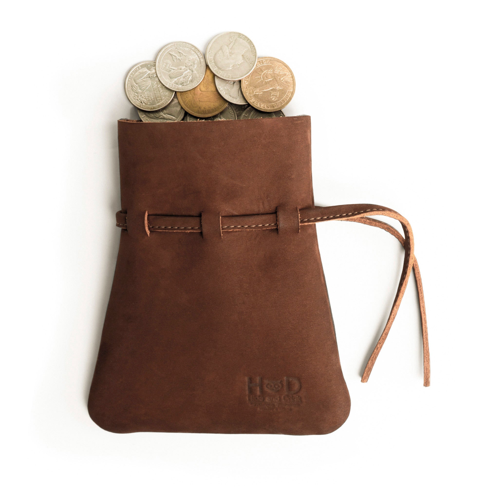 The Medieval Coin Pouch by Hide & Drink, filled with coins, highlights its vintage aesthetics. This Medieval Drawstring Coin Pouch is not only functional but also a unique piece for cosplay enthusiasts, crafted from Full Grain Leather with artisan quality. Proudly handmade in La Antigua Guatemala & Oaxaca Mexico.