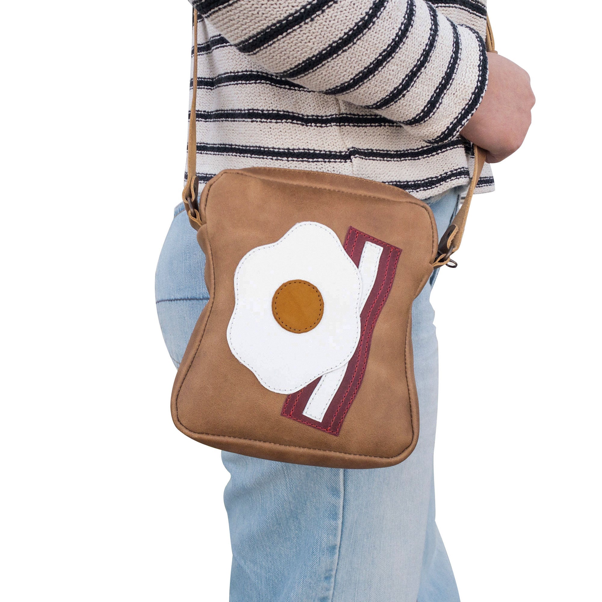 Model displaying the Egg and Bacon Sandwich-Shaped Shoulder Bag by Tudi Frudi, emphasizing its versatile and stylish nature as a Handbag, Crossbody Bag, or Messenger Bag. Made from Full Grain Leather, small batch produced with Hand Cut and Hand Sewn craftsmanship, reflecting artisan quality from La Antigua Guatemala.
