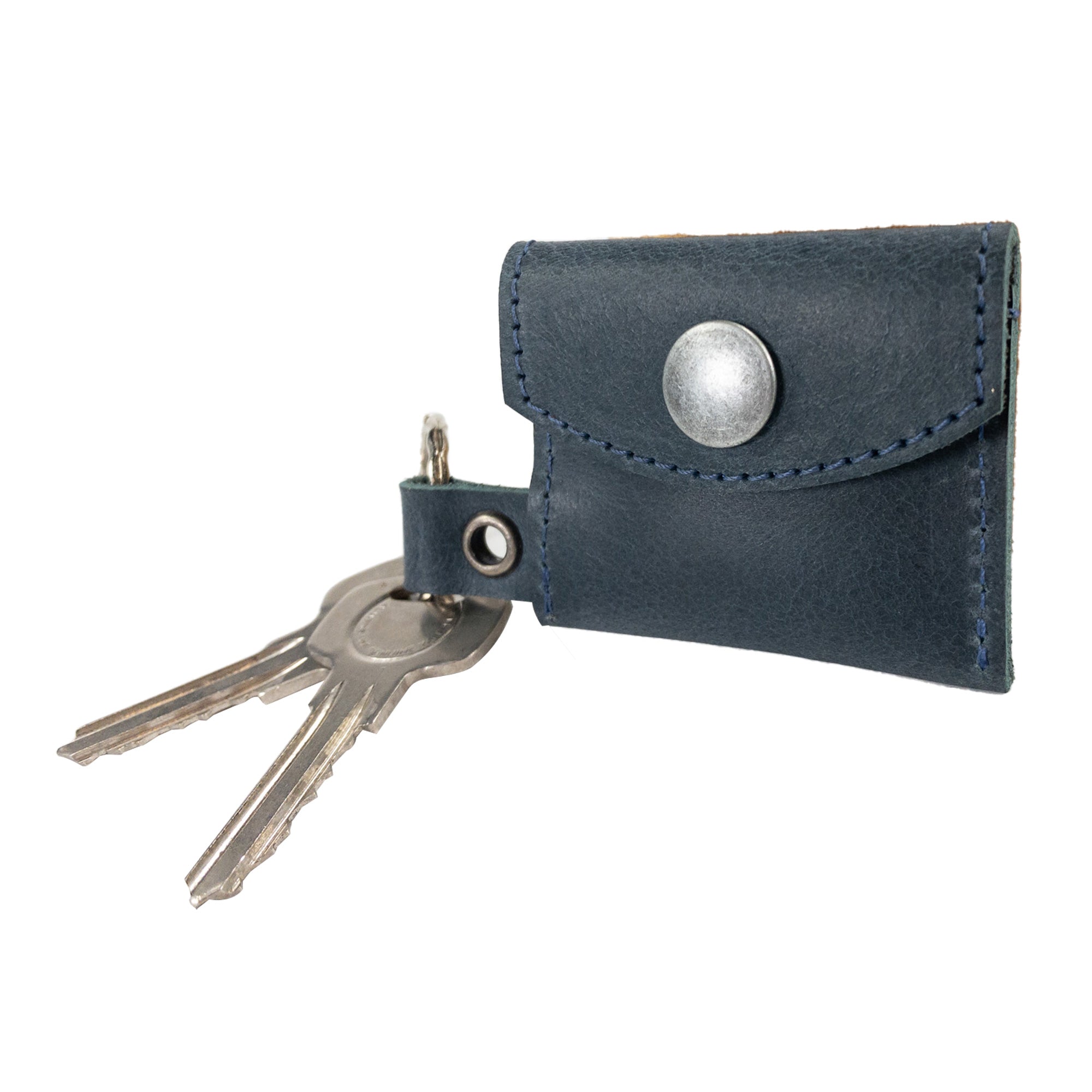 Stylish showcase of the Tiny Coin Holder Keychain by Hide & Drink, seamlessly integrating into lifestyle choices. This accessory crafted from Full Grain Leather is a product of dedicated small batch artisan production.