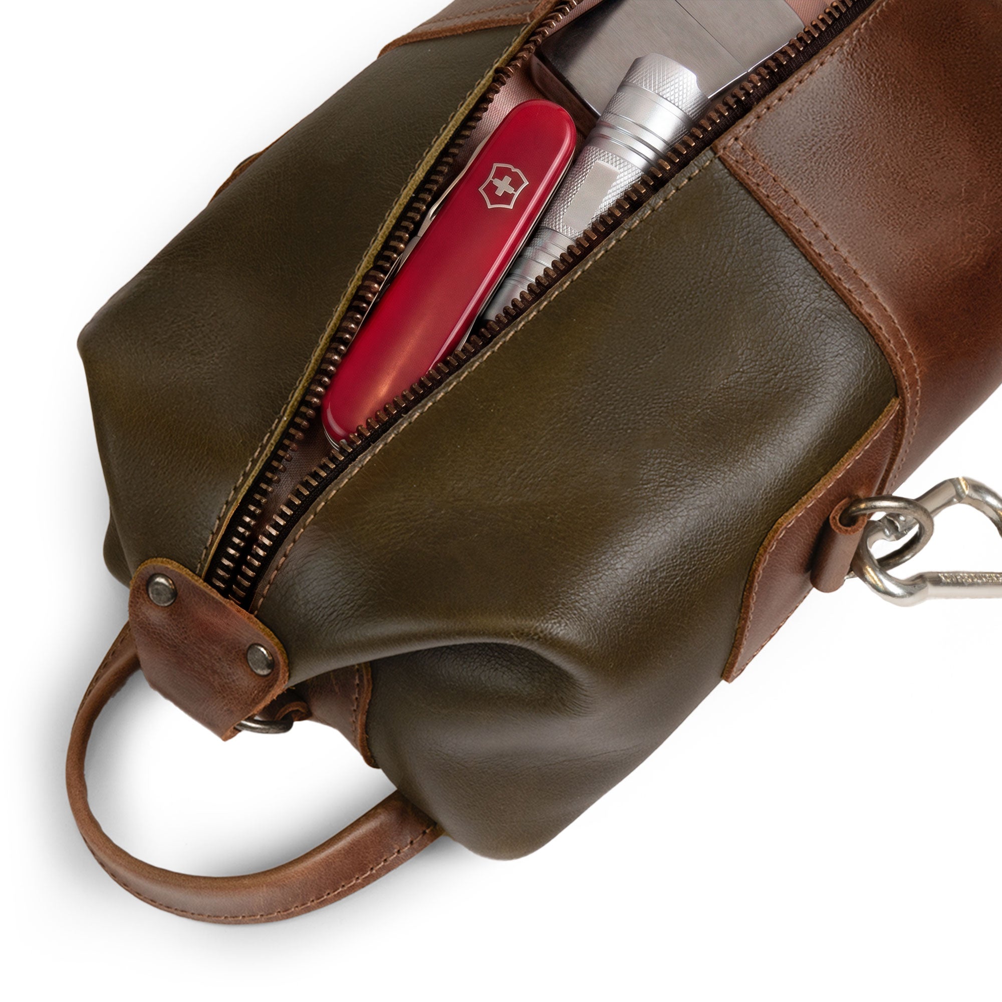 An overhead shot of the Vintage Adventure Dopp Kit by Littlefield Chicago, revealing its contents like grooming tools, exemplifying its use as an effective toiletries organizer for men, crafted from full grain leather in small batch production.