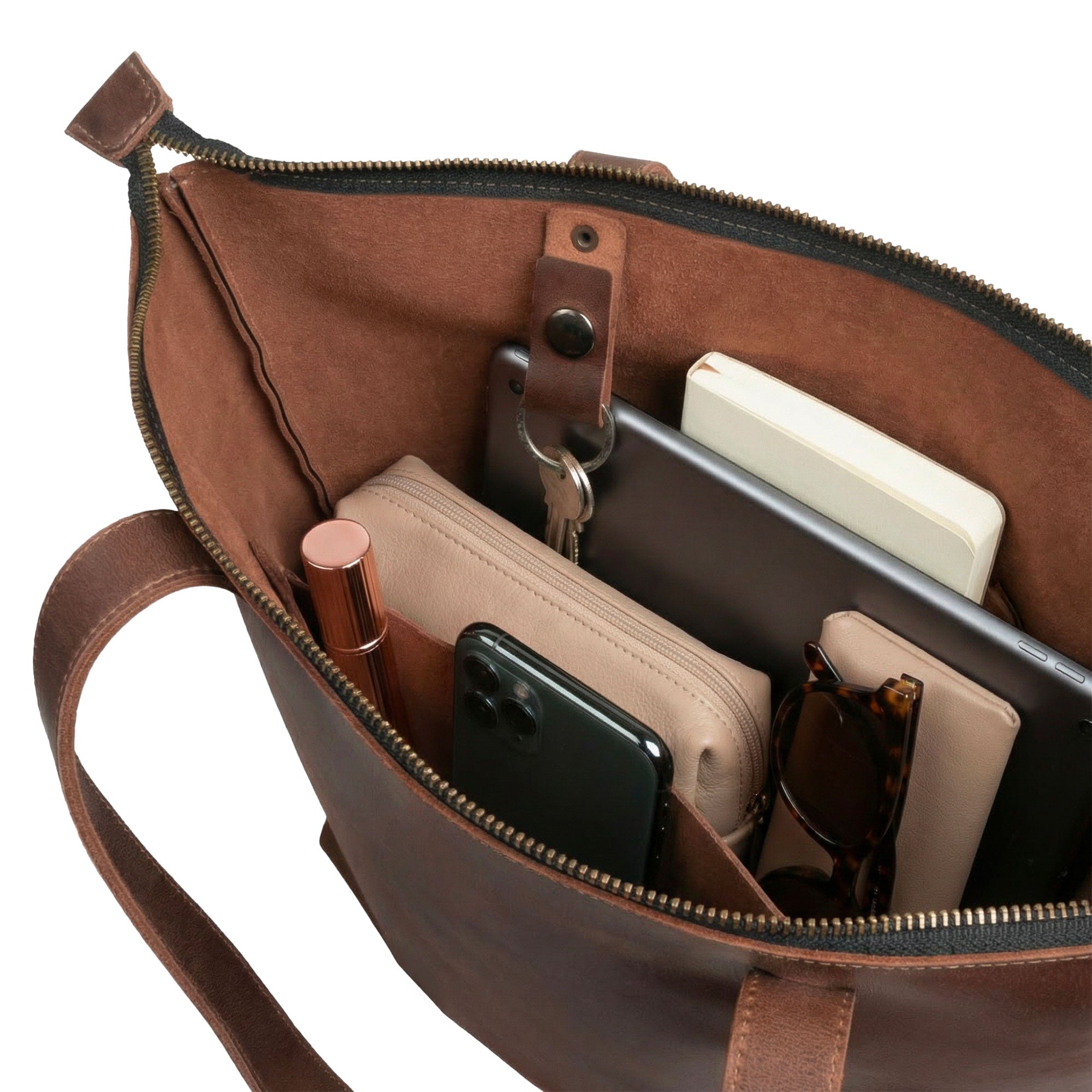 A close-up of The Juniper Zippered Tote Bag's interior compartments, featuring a meticulously organized space for essentials. This full grain leather tote, crafted by Austin Genuine, reflects the vibrant culture and handmade excellence found in La Antigua Guatemala and Oaxaca Mexico.