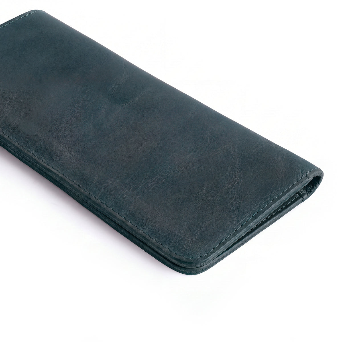 Closed view of the black bifold wallet for cellphone by Hide & Drink, showcasing its elegant and functional design. This Bifold Wallet for Cellphone made from Full Grain Leather is ideal for everyday use. Appreciate the artisan craftsmanship and small batch production from La Antigua Guatemala & Oaxaca Mexico.