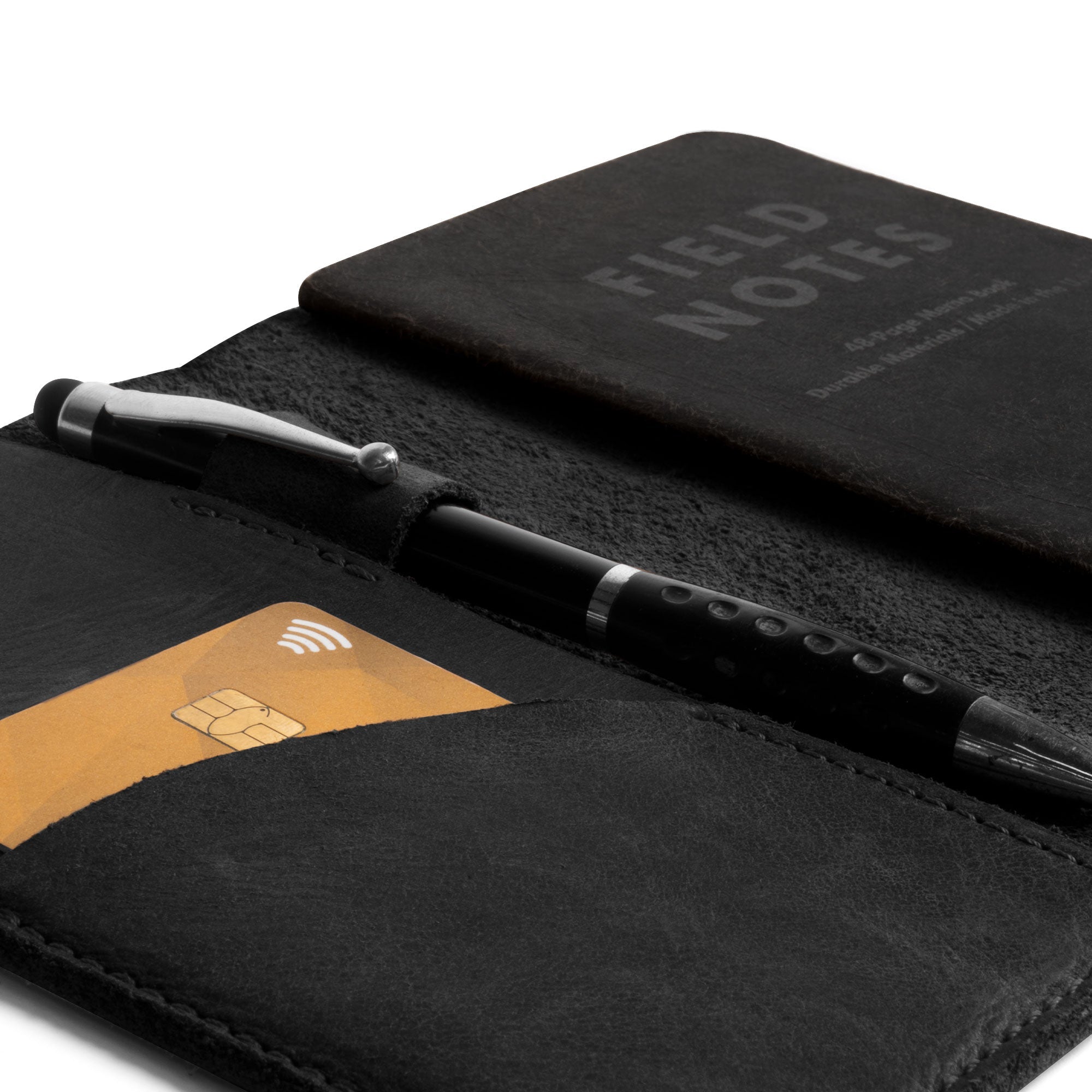 Close-up of the black Field Notes Carrier's inside, revealing the card pocket and pen holder by Leather Worx. This Field Notes Cover is the ideal Leather Notebook Cover 3.5 x 5.5 in., providing both efficiency and style. Crafted from full grain leather with attention to detail, it is a must-have for travelers, made in La Antigua Guatemala.