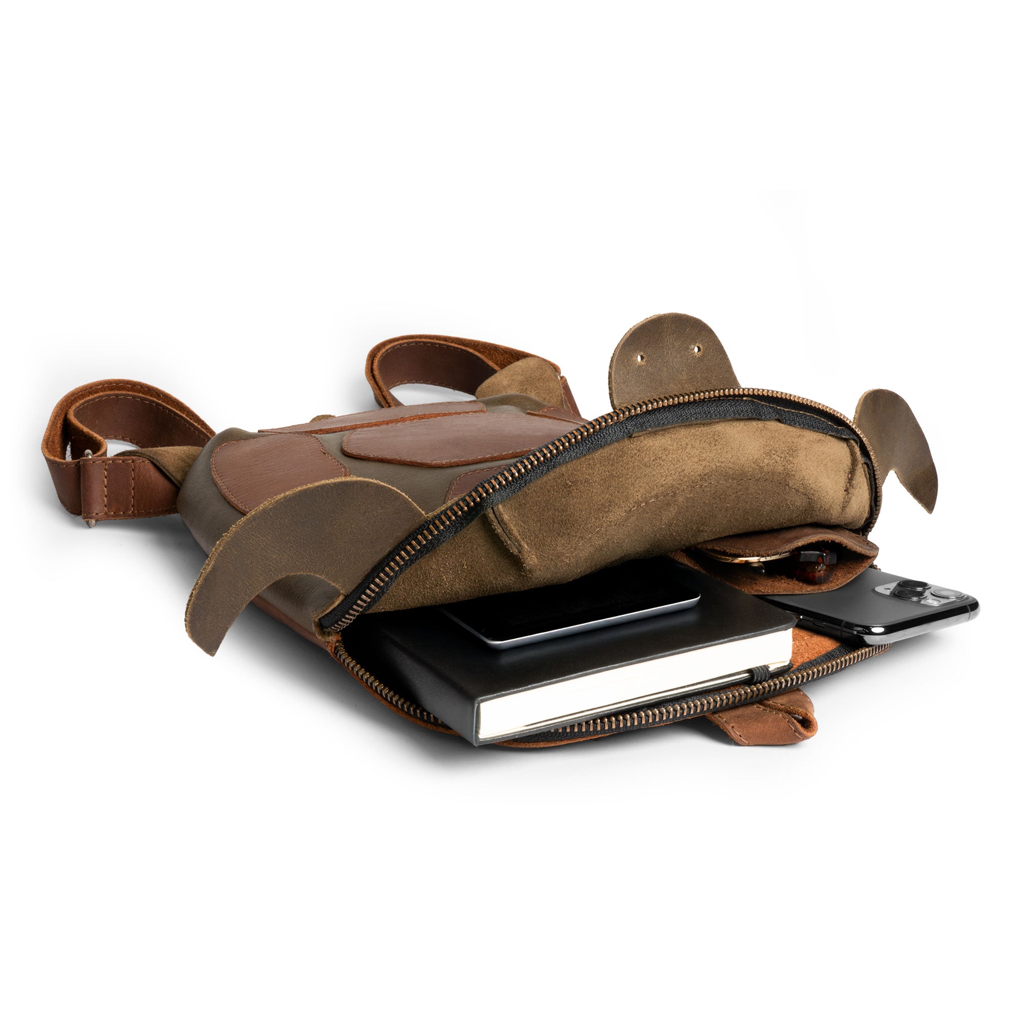 An open Turtle-Shaped Backpack by Hide & Play, revealing its spacious interior. This versatile bag can be used as a Casual Bag, Messenger Bag, or Travel Bag for Men and Women. Made from Full Grain Leather, it highlights StockyardX's Small Batch Production with its hand cut, hand sewn details, and artisan touch crafted in La Antigua Guatemala.