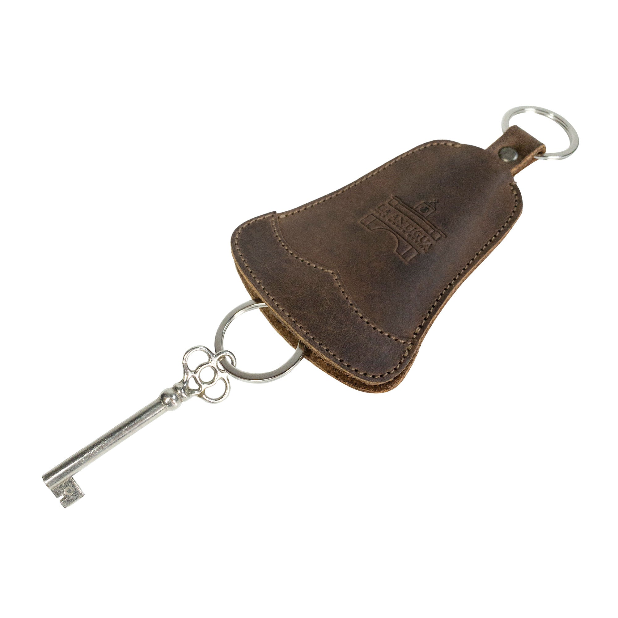 The Bell Shape Keychain from La Antigua displayed with a vintage key, illustrating its role as a stylish keyring with strap. Ideal key organizer that facilitates easy attachment to keys. Made from high-quality full grain leather, this handcrafted item embodies small batch production, meticulously hand cut, hand sewn, and fire branded by artisans in La Antigua, Guatemala & Oaxaca, Mexico.