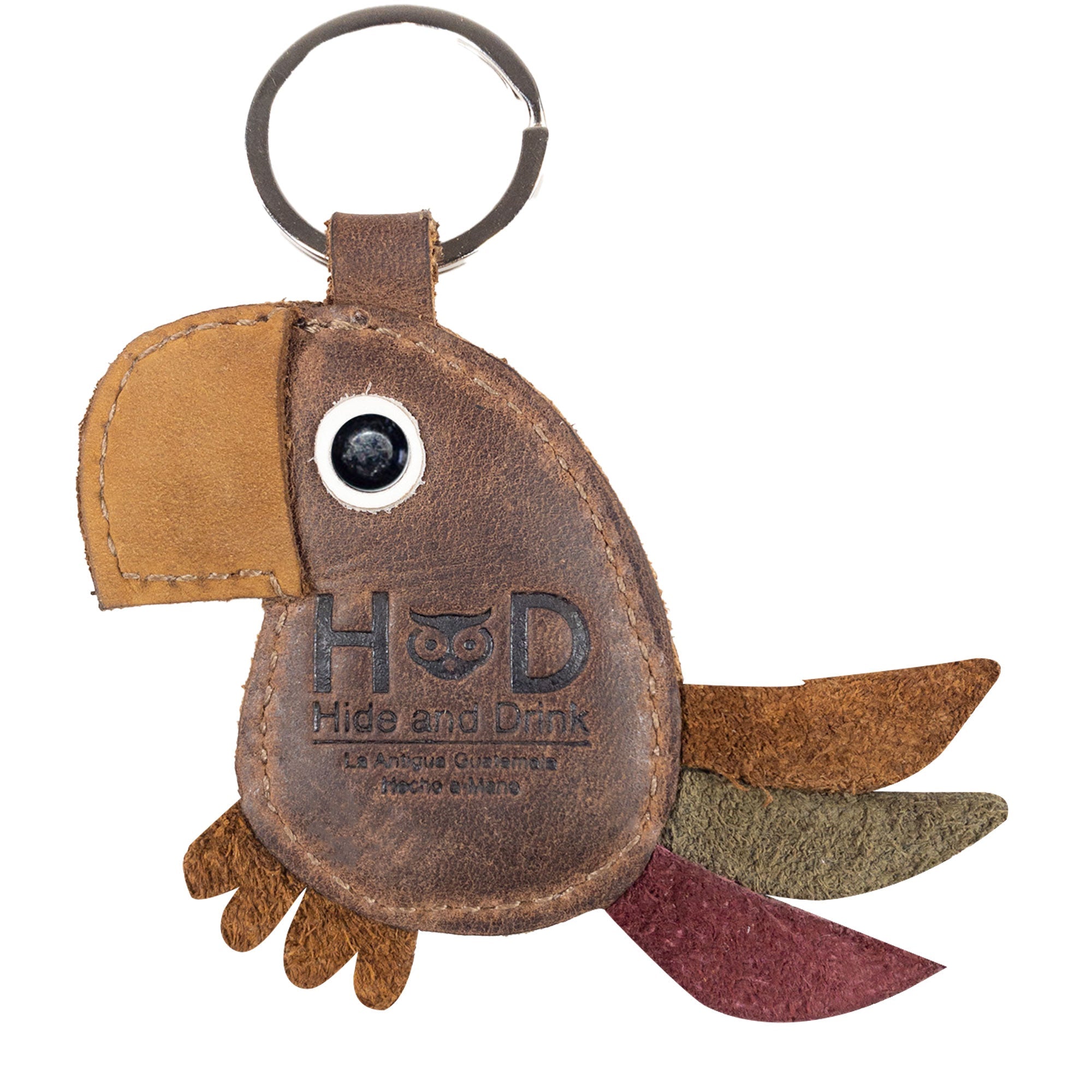 Hide & Drink's Toucan Keychain with branding, illustrating quality full grain leather construction. Ideal as an animal-shaped keyring or decorative ornament for backpacks and handbags, this item is handmade in La Antigua Guatemala & Oaxaca Mexico, showcasing small batch production with hand cut and hand sewn craftsmanship.