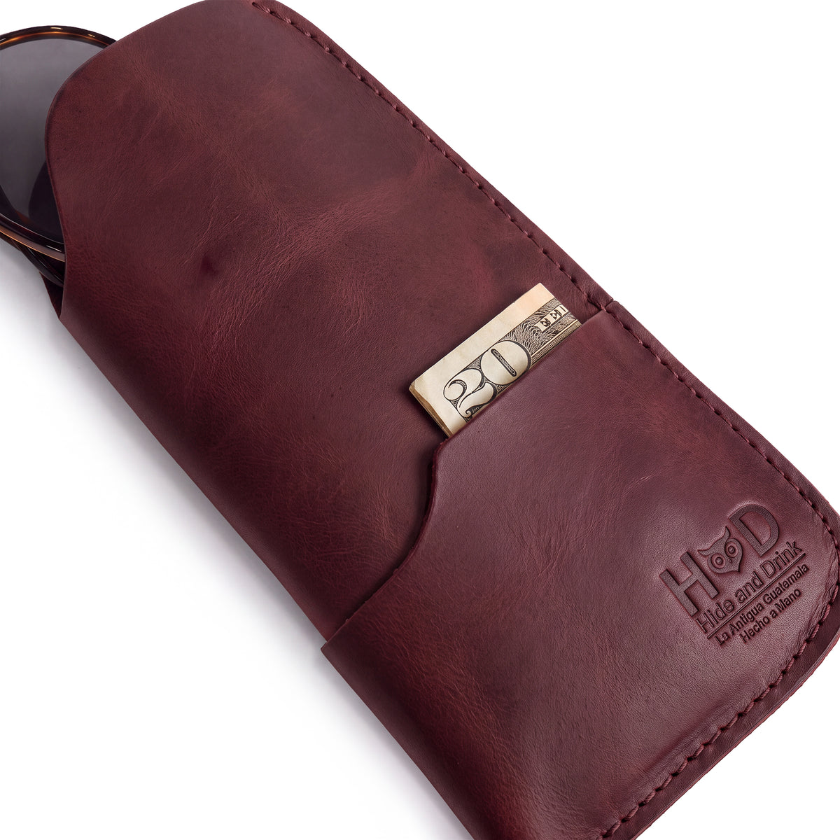 The Hide & Drink Sunglass Case & Wallet presented in a tan finish, confirming its rustic charm. This Rustic Sunglasses Case & Wallet provides excellent protection as a Full Grain Leather glasses protector for travel, inspired by artistry from La Antigua Guatemala & Oaxaca Mexico.