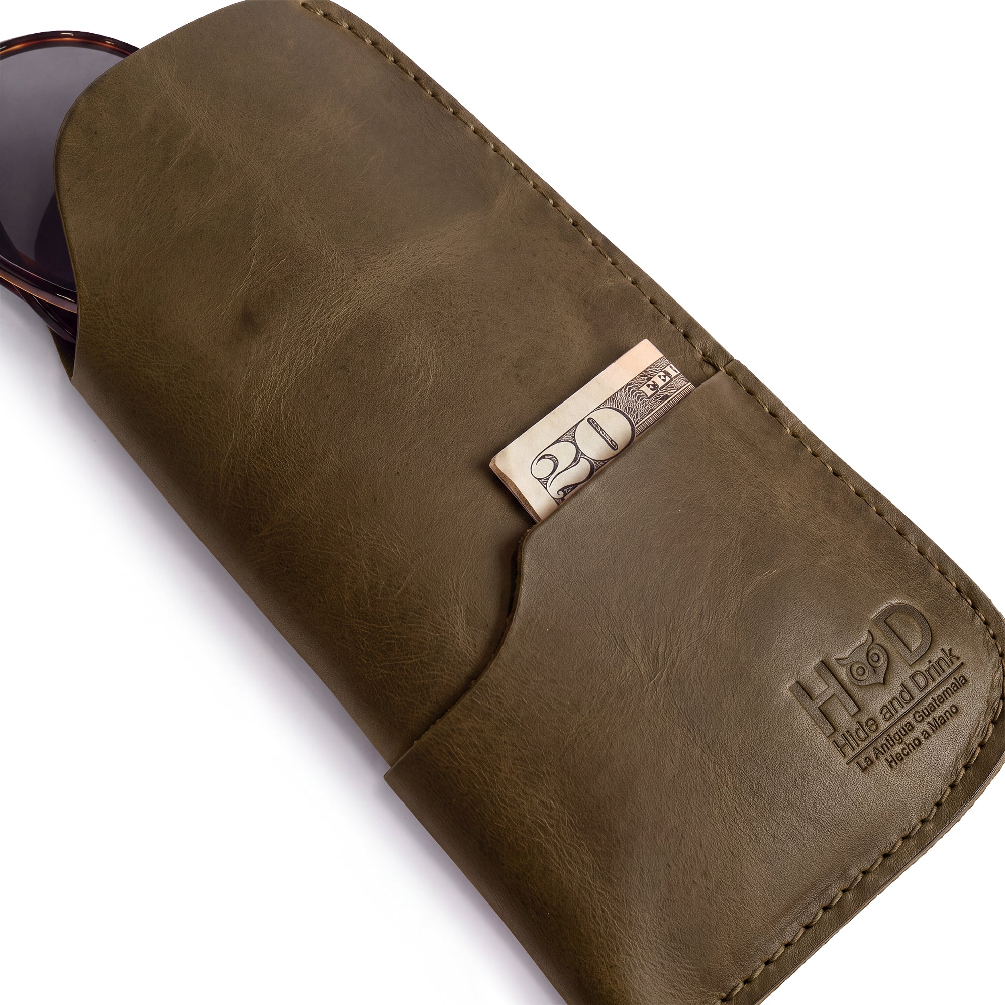 Showcase of the Hide & Drink Sunglass Case & Wallet in red leather, adding a pop of color to your style. This Rustic Sunglasses Case & Wallet features Full Grain Leather craftsmanship, making it an ideal glasses protector for travel, hand-cut and hand-sewn in La Antigua Guatemala & Oaxaca Mexico.