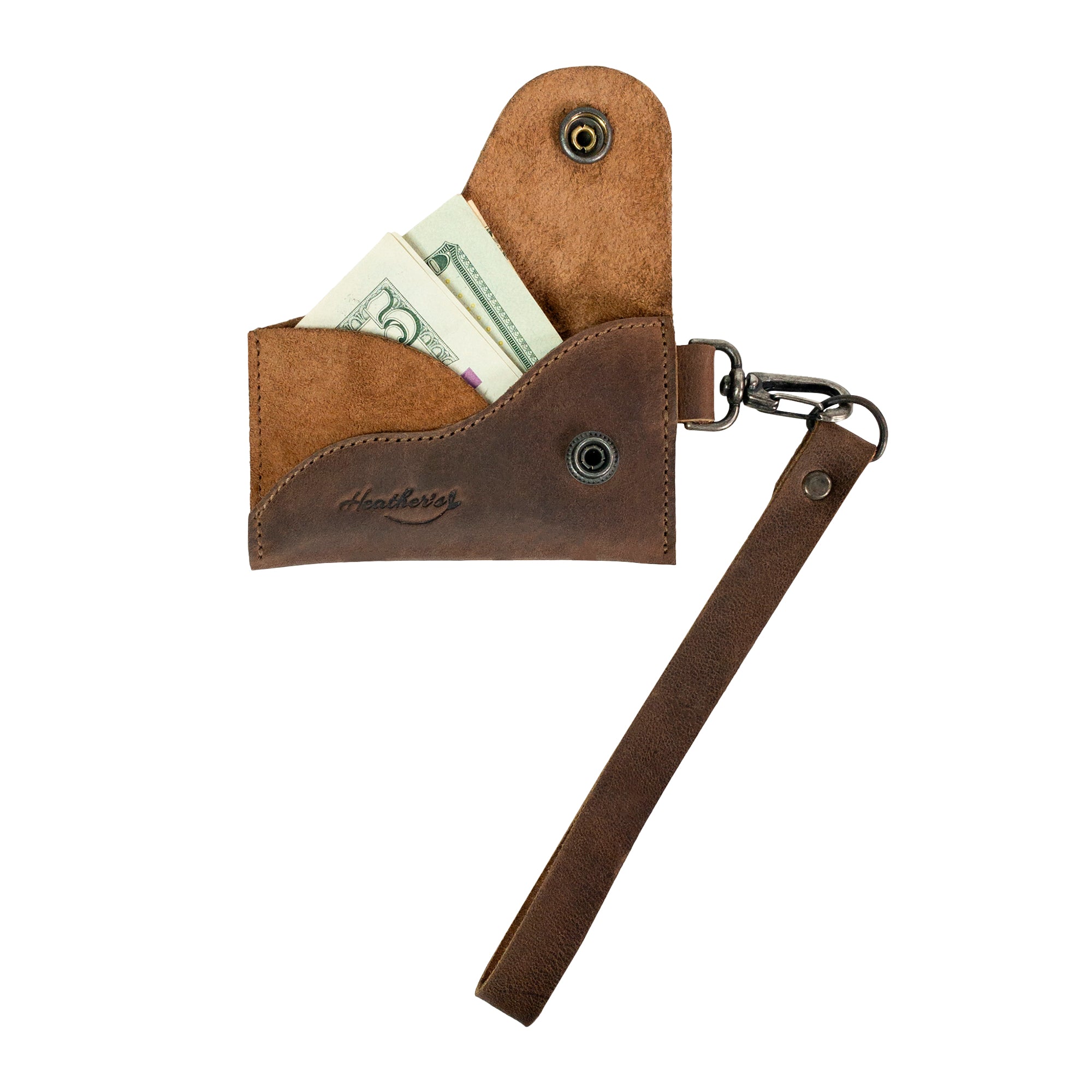 Close-up of the Heather's Female Wallet with Wristlet, displaying its ID case with wrist strap and cash storage features. Made from full grain leather, this wallet is ideal for organizing money and essentials while traveling, handcrafted by artisans in La Antigua Guatemala and Oaxaca Mexico.