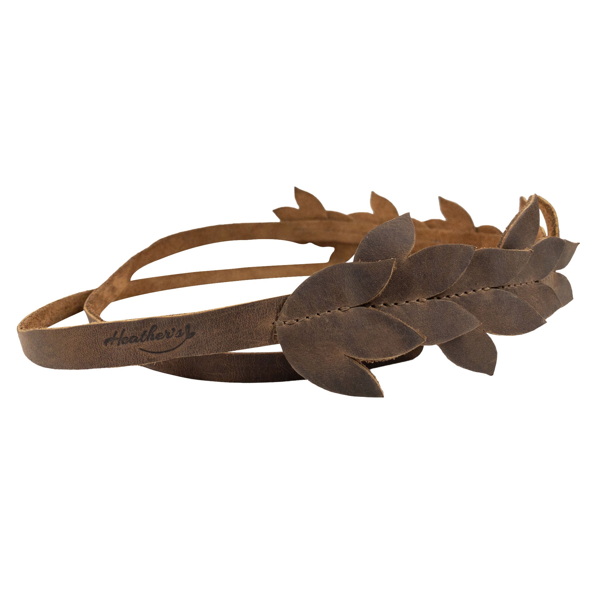 Close-up of Heather's Flowered Headband showcasing its elegant floral design made from full grain leather. This rustic headband serves as a beautiful hair accessory for women, crafted through hand cut and hand sewn techniques, reflecting the passion of artisans from La Antigua Guatemala.