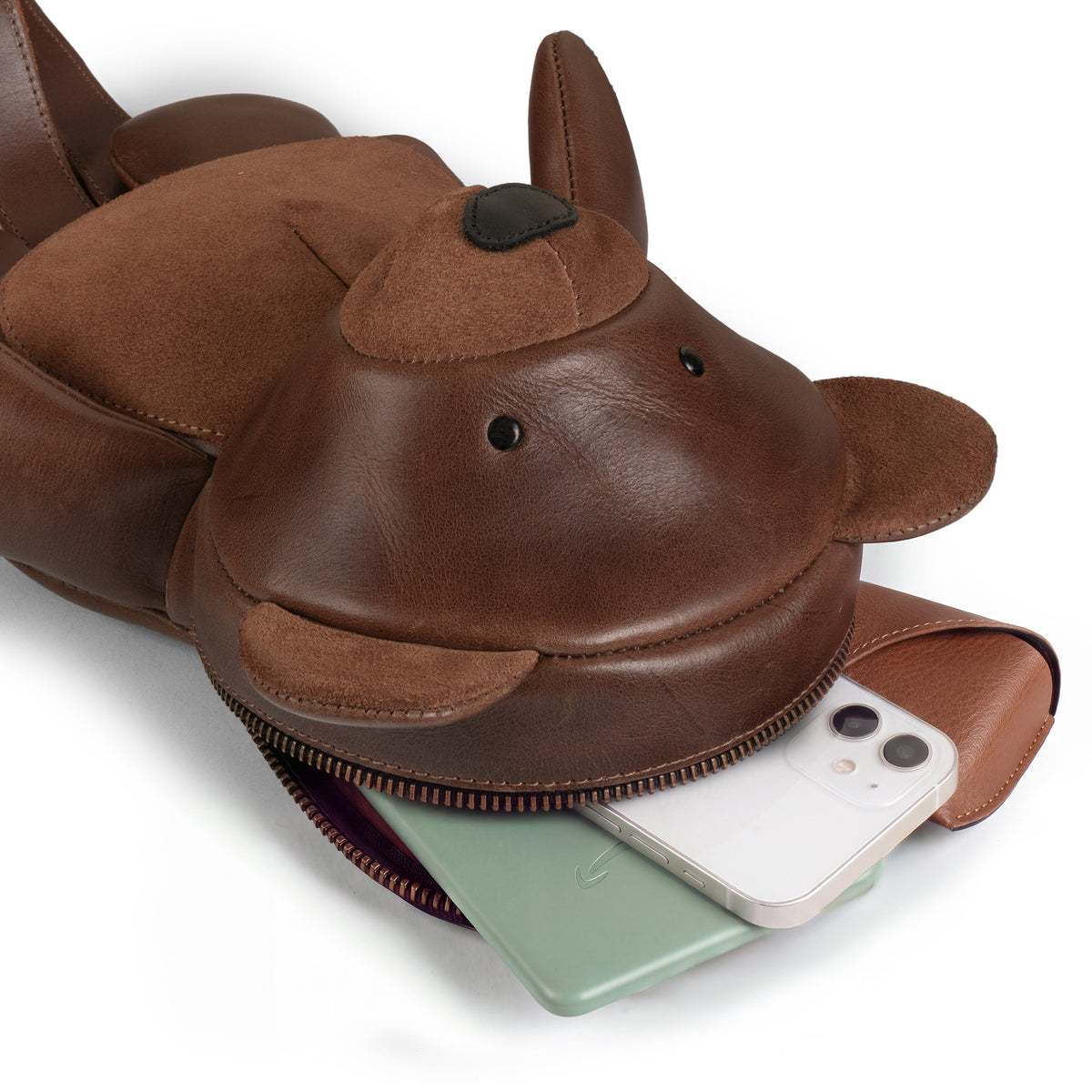 Close-up of the Tudi Frudi Leather Teddy Bear Crossbody Bag opened to show its zippered compartment holding a smartphone, highlighting the Messenger Bag, Shoulder Bag, Zippered Sling Bags, Travel Backpack, Purses for Men and Women, and Satchel design in Full Grain Leather with an Adjustable Shoulder Strap from StockyardX, created through Small Batch Production, Hand Cut, Hand Sewn, Fire Branded, Artisan, Handmade in La Antigua Guatemala & Oaxaca Mexico.