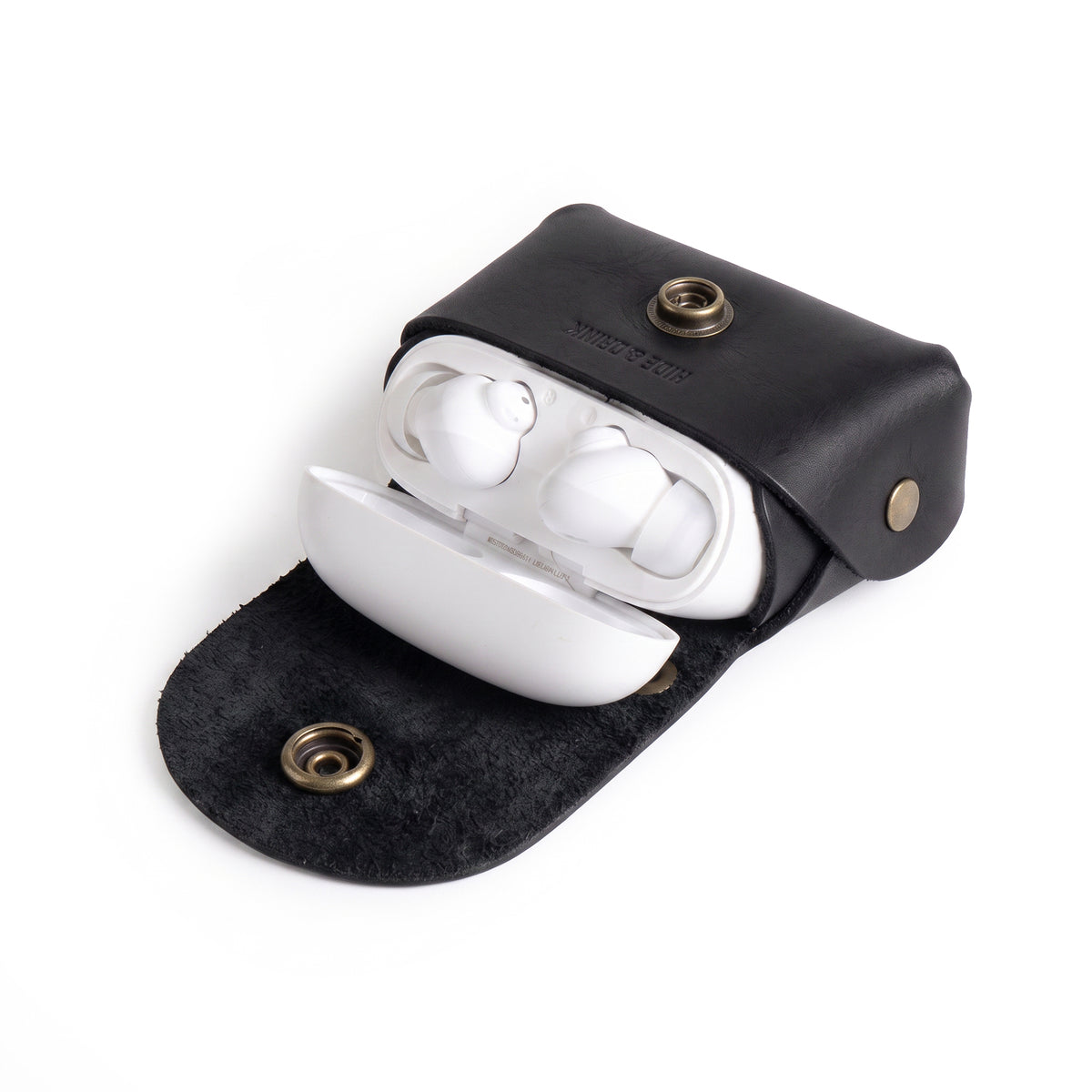 Interior view of the black Tiny Handbag Keychain by Hide & Drink, displaying keys and coins. Crafted from Full Grain Leather, this artisanal product represents small batch production and showcases excellent hand cut and hand sewn craftsmanship.