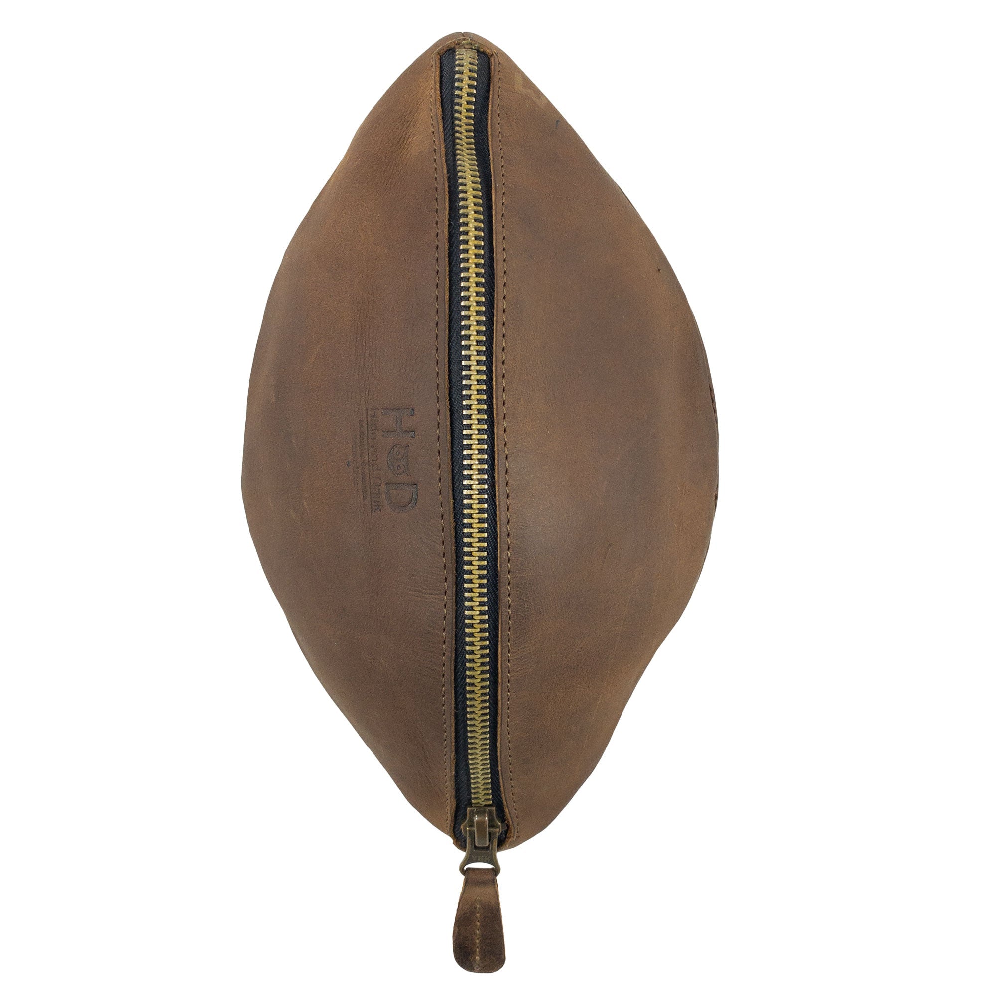 Side view of the Football Toiletry Bag by Hide & Drink with a prominent zipper. This stylish, full grain leather Gameday Football Dopp Toiletry Bag is designed for organizing grooming essentials and shaving kits effortlessly. Crafted in La Antigua Guatemala, it features artisanal details from small batch production, including hand cut and hand sewn techniques.