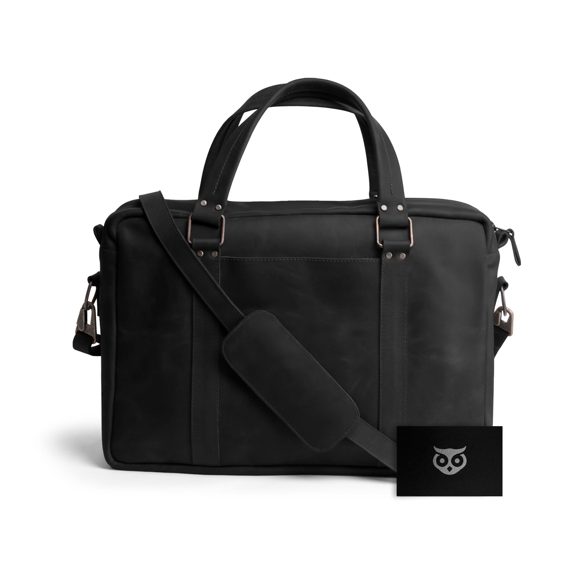 The sleek design of the Classic Leather Briefcase by Hide & Drink in black, showcasing its craftsmanship in Full Grain Leather. This messenger bag features an adjustable shoulder strap and a inner water resistant canvas lining, making it an excellent choice for professionals. Handmade in La Antigua Guatemala, it emphasizes the brand's commitment to artisan quality in small batch production.