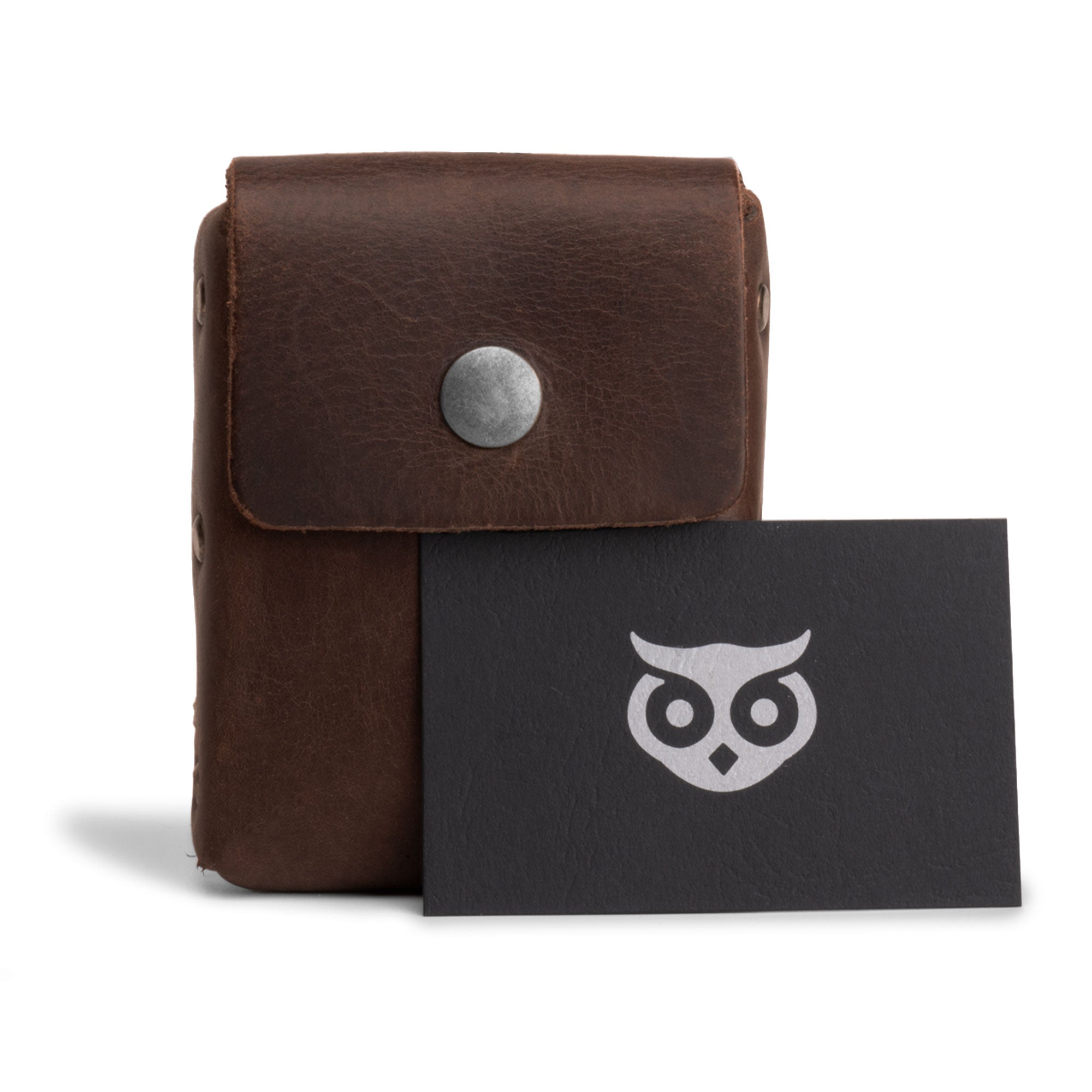 Hide & Drink's Waist Wallet alongside a branded card, showcasing its functionality to hold up to 20 cards, folded bills & coins, charging cables, crafted from rich full grain leather with a focus on small batch production, hand cut, hand sewn, fire branded, artisan quality, handmade in La Antigua Guatemala & Oaxaca Mexico.
