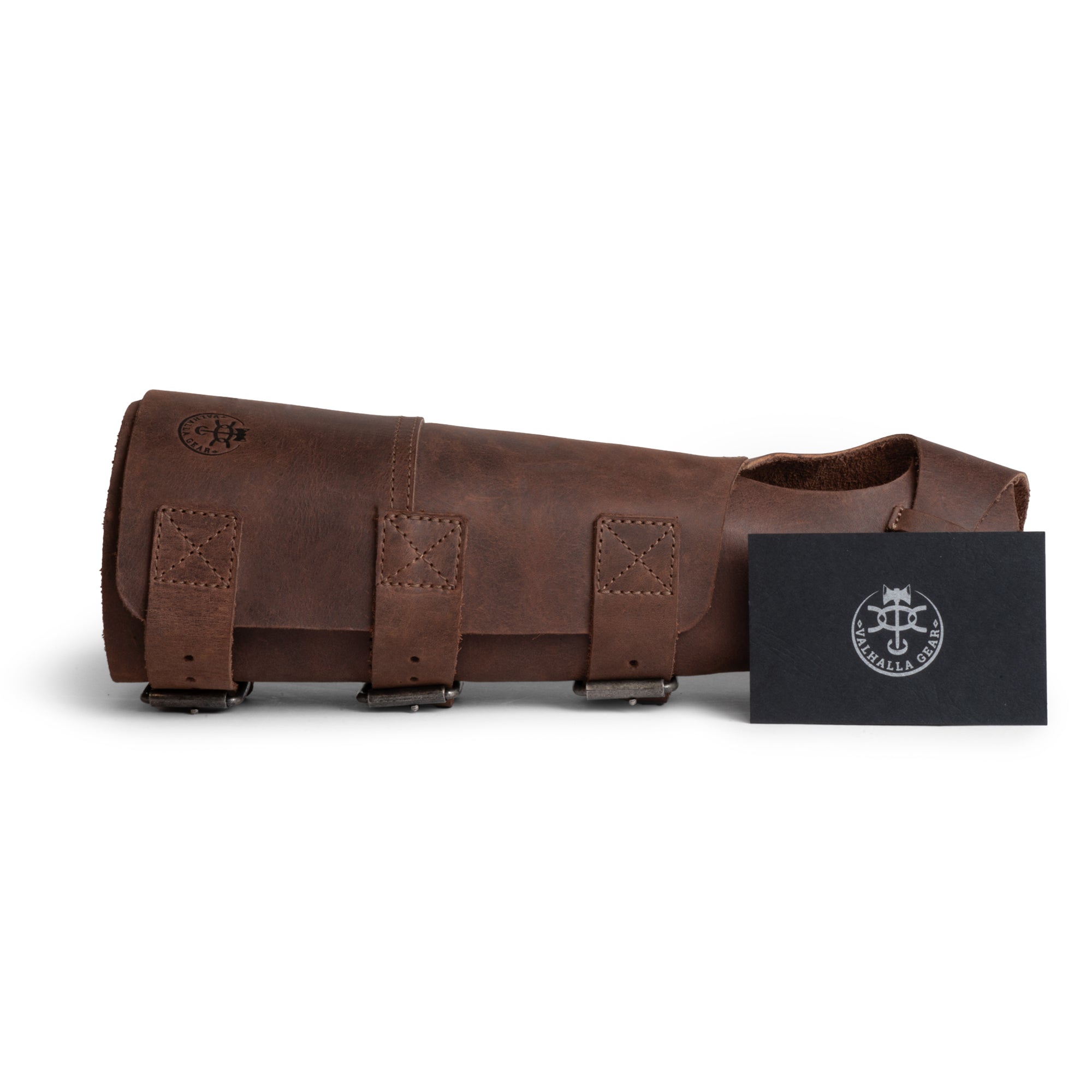 Valhalla Gear Welding Forearm Protector with accompanying tag, emphasizing its handmade quality and materials sourced from Guatemala. This full grain leather forearm protector is a unique addition to any blacksmith's toolkit, ensuring both safety and style.
