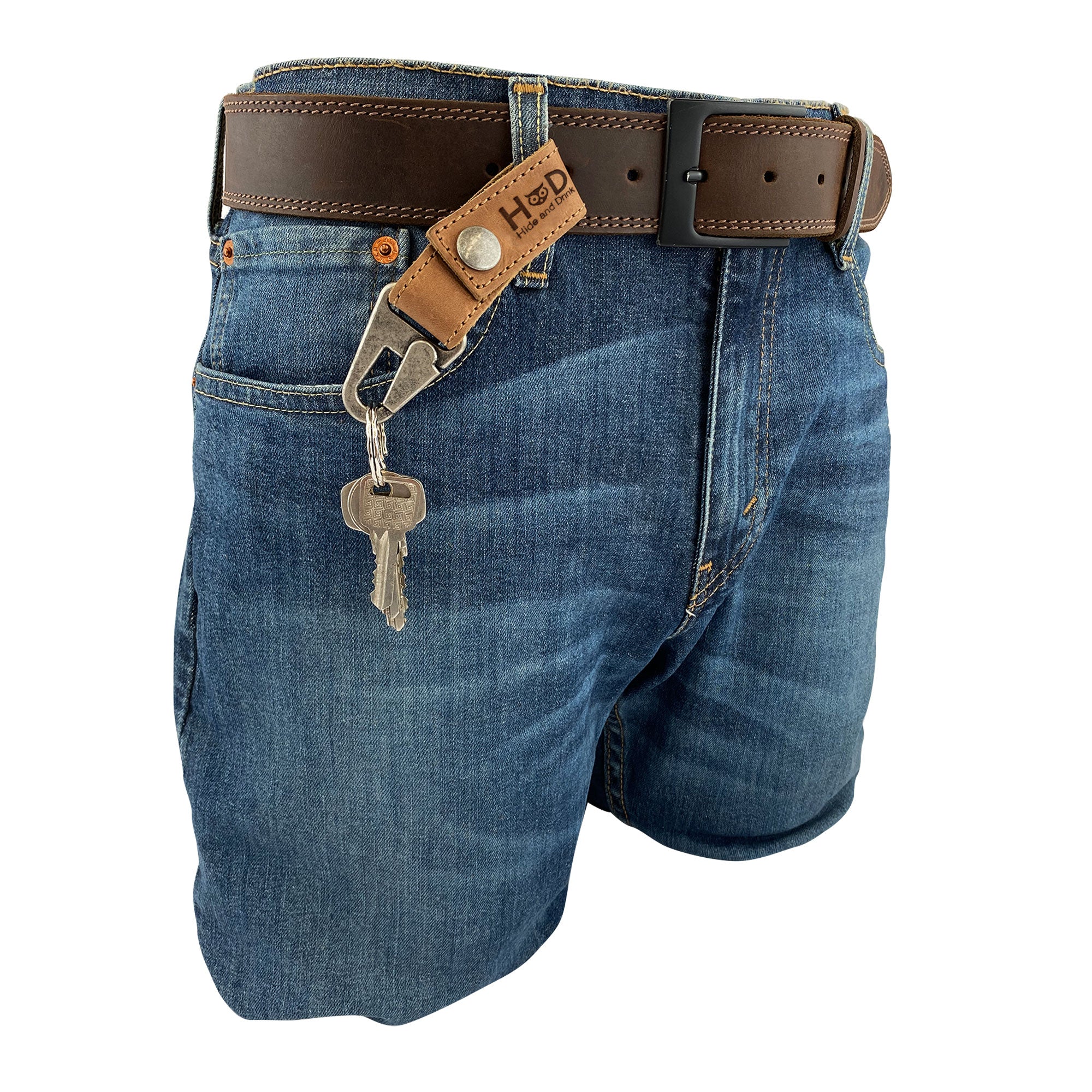 A stylish Key Ring Holder by Hide & Drink, featuring rustic Full Grain Leather attached to jeans, perfect for keeping your keys organized. This piece reflects Small Batch Production and Artisan craftsmanship, made Hand Cut and Hand Sewn in La Antigua Guatemala & Oaxaca Mexico.