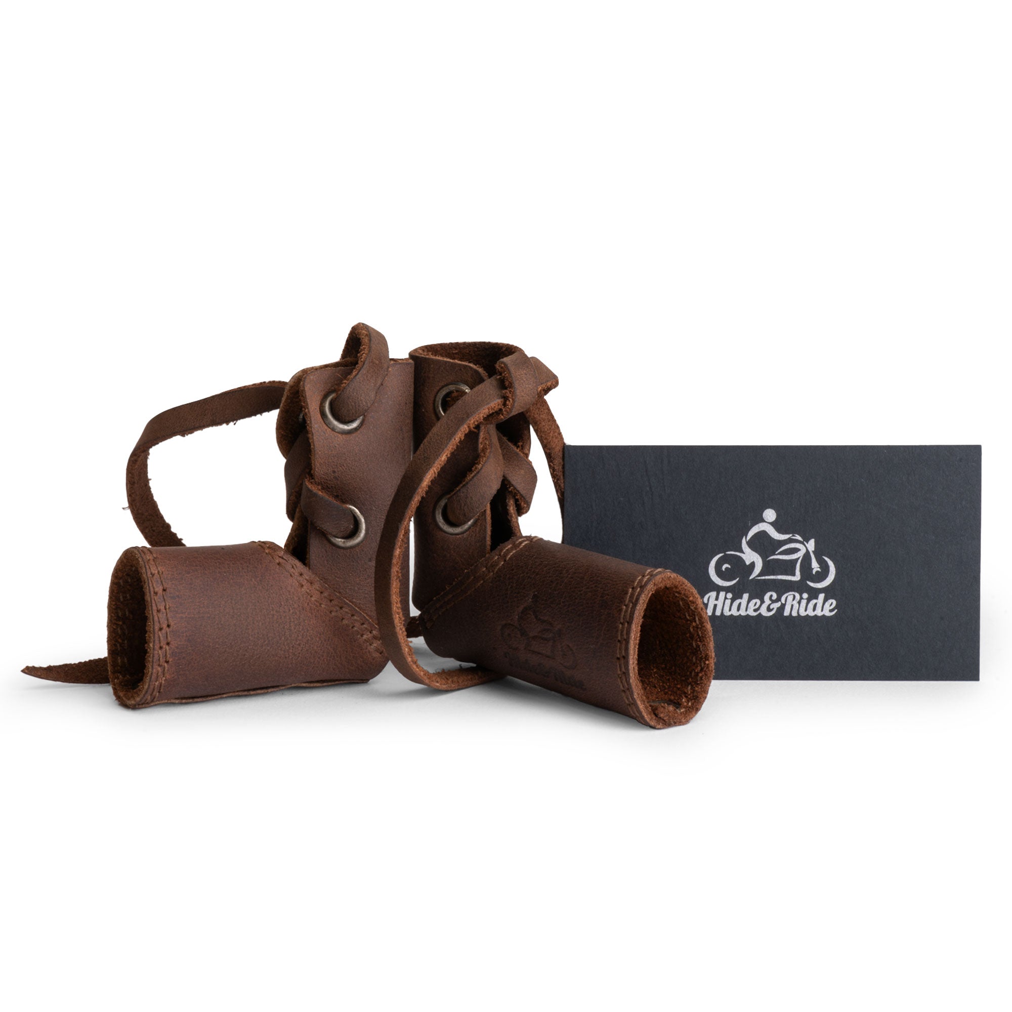 A beautiful shot of the Hide & Ride Shift Lever Socks displayed with a tag, emphasizing their handmade craftsmanship in full grain leather. Perfect for motorcycle lovers, these durable gear covers protect shoes while adding a touch of artisan flair, made in La Antigua Guatemala.