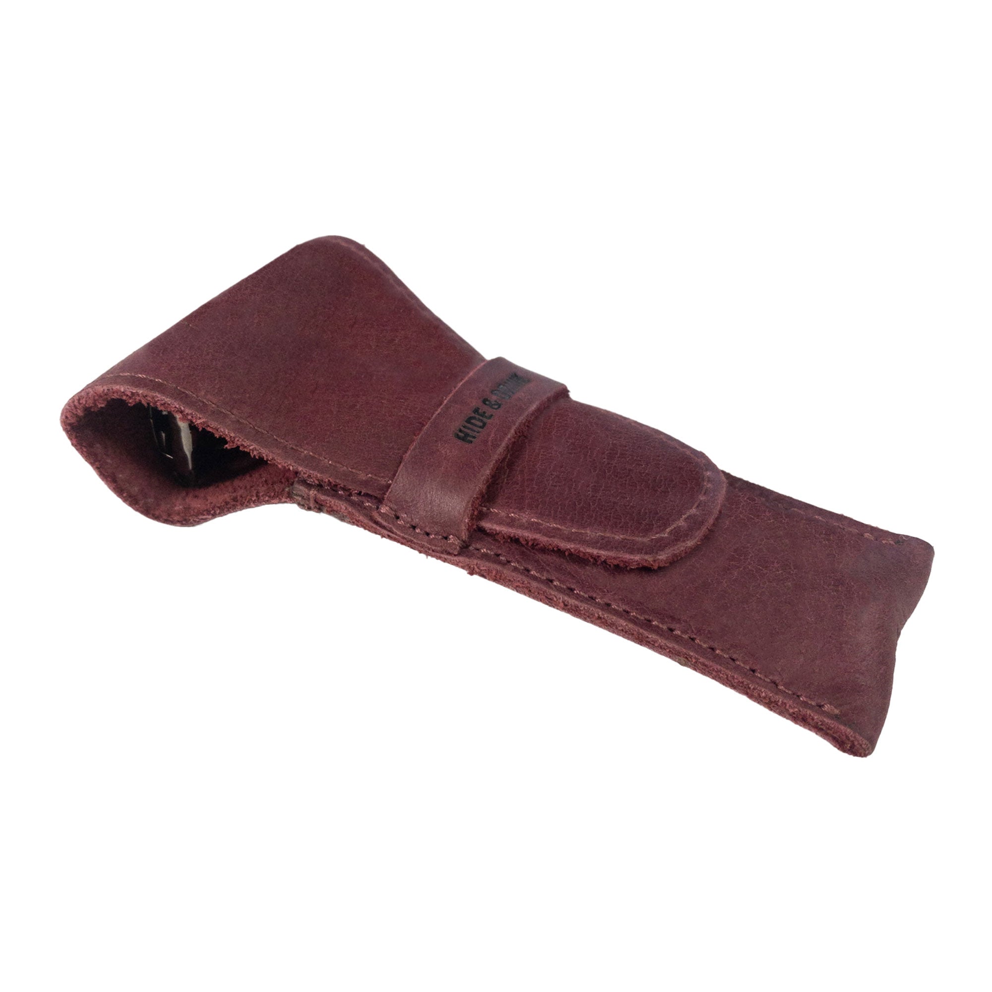 The closed Safety Razor Case by Hide & Drink in a deep burgundy color, exemplifying the perfect blend of style and functionality. This artisan item, crafted from Full Grain Leather, ensures your shaving essentials are protected and organized for travel.