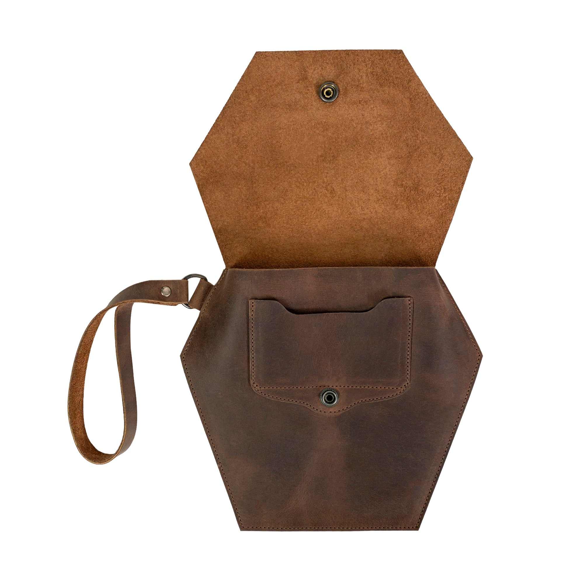 Inside of Heather's Hexagonal Clutch Bag, highlighting the storage space for essentials. This versatile clutch adds style while serving as a travel handbag for makeup and toiletry items. Made from Full Grain Leather, each bag reflects the artisan craftsmanship of small batch production in La Antigua Guatemala & Oaxaca Mexico.