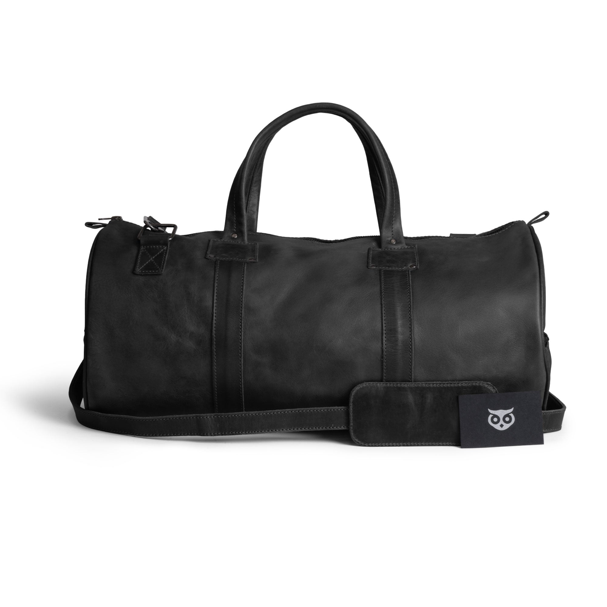 Classic Duffle Bag by Hide & Drink in dark brown leather, presenting a roomy interior for travel essentials with zipper closure and adjustable strap. This Full Grain Leather Classic Duffle Bag is a refined Messenger Bag option, crafted by artisans in La Antigua Guatemala & Oaxaca Mexico.