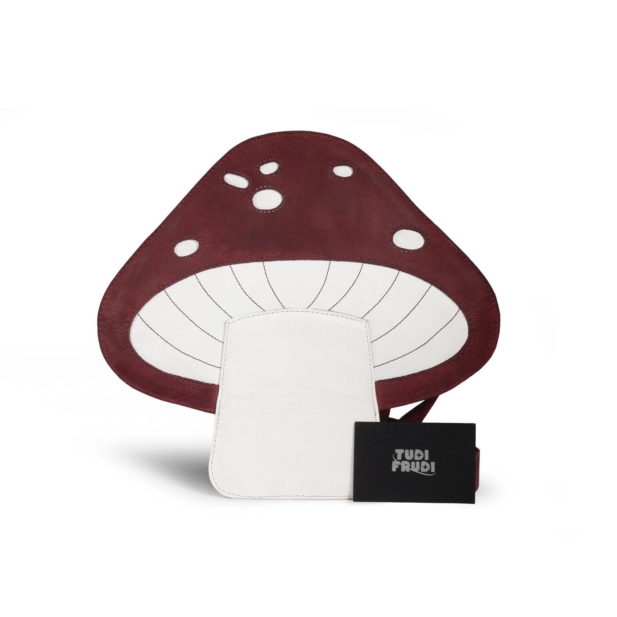 The Mushroom-Shaped Leather Shoulder Bag by Tudi Frudi, complete with tags and branding, showcasing its unique handmade qualities. This bag is perfect for use as a crossbody or messenger bag, made from Full Grain Leather with small batch production, reflecting artisan craftsmanship from La Antigua Guatemala.