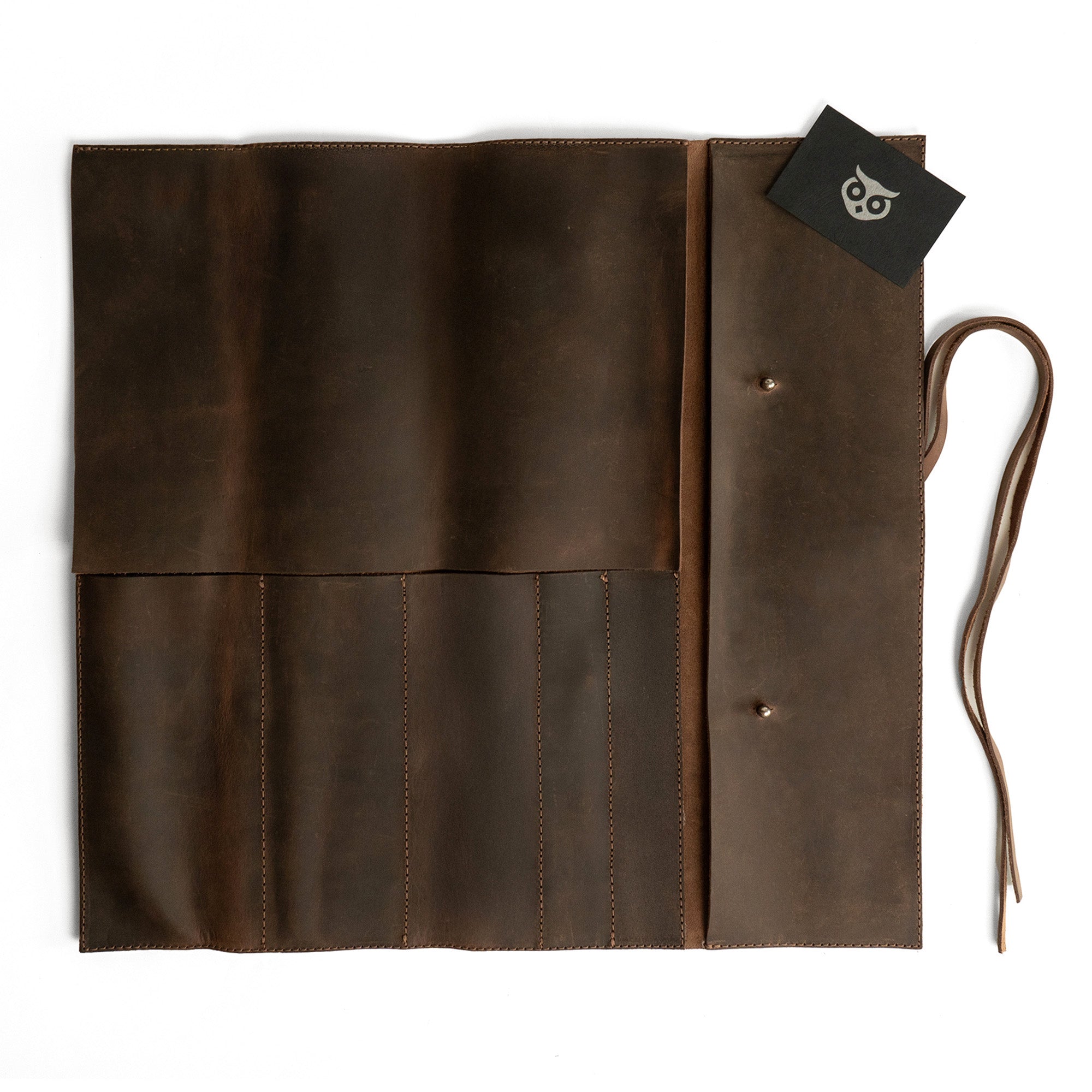 Hide & Drink Knife Roll (5 Pockets) neatly folded, beautifully made from Full Grain Leather. This Chef Knife Bag serves as a portable carrying case for knives, showcasing artisan skills with its handmade, small batch production, where each piece is hand cut and hand sewn.