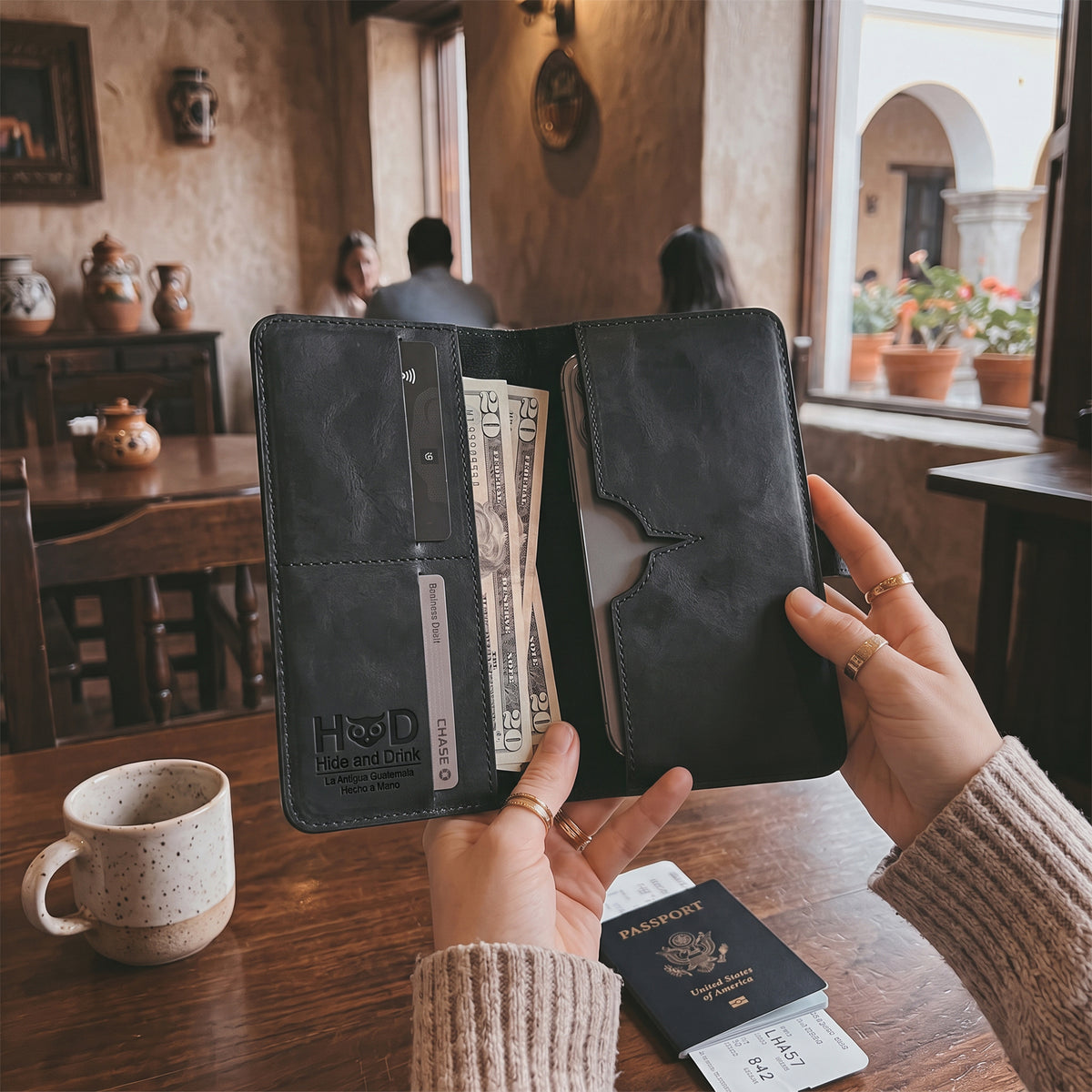 Exterior view of the closed black bifold wallet for cellphone by Hide & Drink, emphasizing its sleek design. This Bifold Wallet for Cellphone combines functionality with style, crafted from high-quality Full Grain Leather. Experience the unique artisan touch from small batch production in La Antigua Guatemala & Oaxaca Mexico.