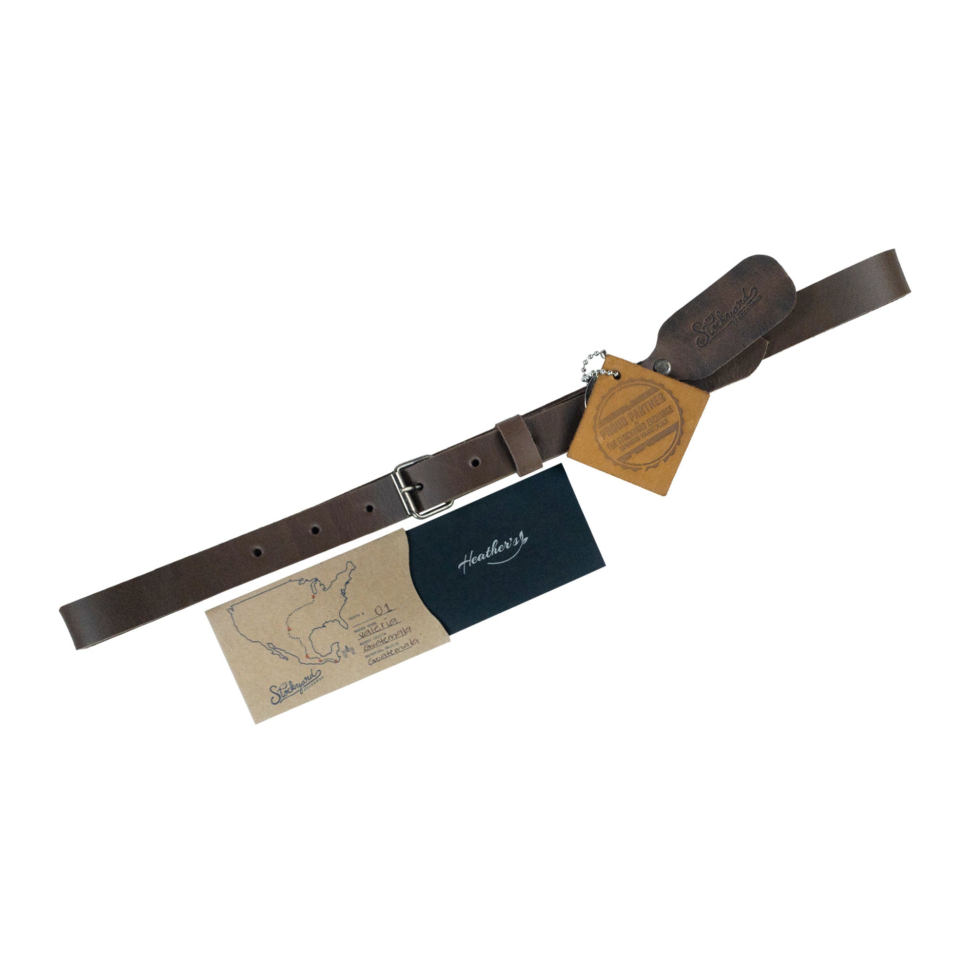 Heather's Rustic Narrow Belt for Women is artfully displayed with its accompanying tags showcasing its artisan craftsmanship. Made of Full Grain Leather, this belt adds a fashionable edge to any outfit while supporting small batch production. Rustic Belt for Women, Narrow Buckle Belt, Stylish Belly Accessory, Small Batch Production, Hand Cut, Hand Sewn, Fire Branded, Artisan, Handmade in La Antigua Guatemala & Oaxaca Mexico.