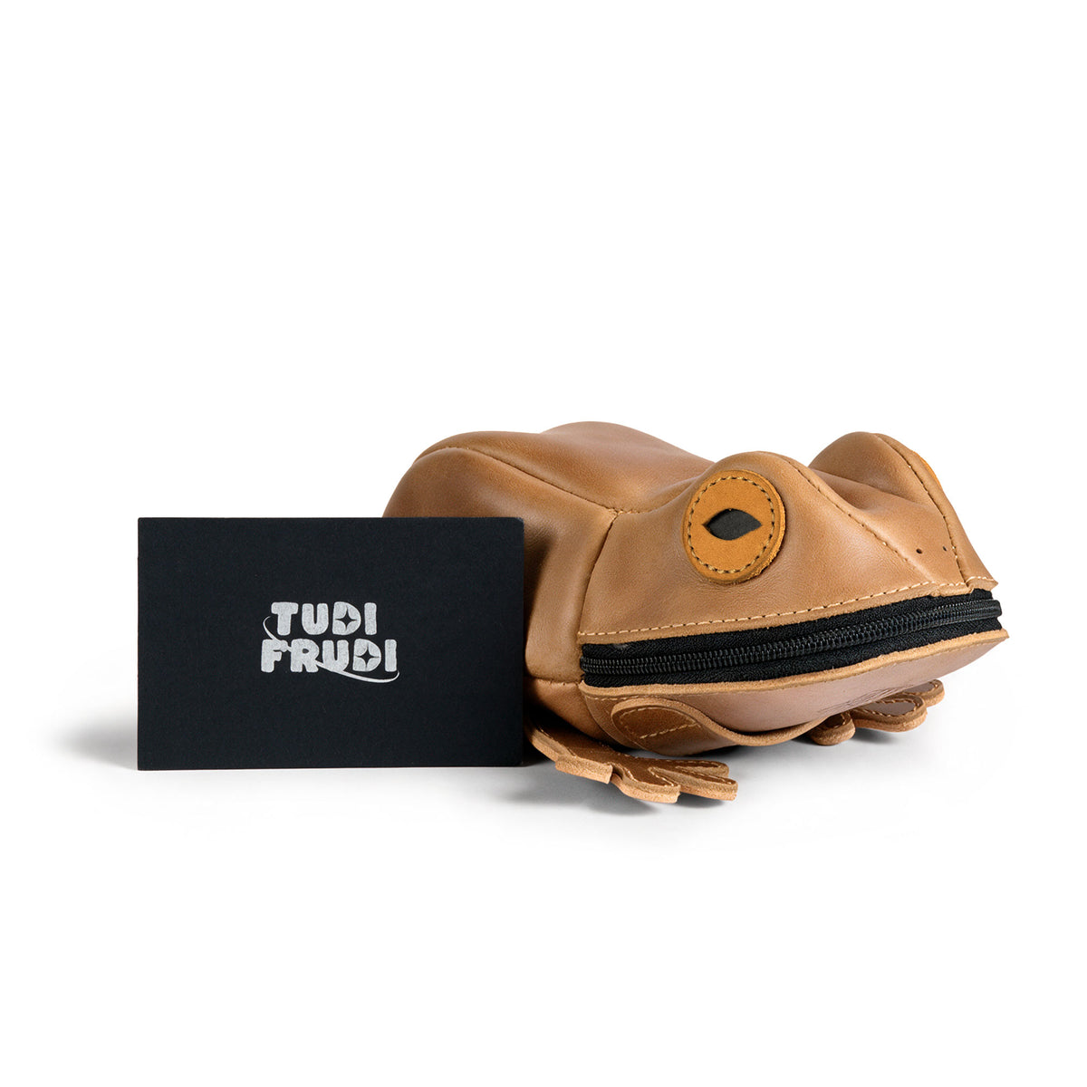 Tudi Frudi Frog Pouch displayed beside its branded card, highlighting the compact Frog-Shaped Pouch and zipper closure as a Cable Organizer, Small Accessory Case, Zippered Cash Holder Wallet for Coins, and Change Purse for Pouches for Men and Women; made from Full Grain Leather by StockyardX through Small Batch Production, Hand Cut, Hand Sewn, Fire Branded, Artisan, Handmade in La Antigua Guatemala & Oaxaca Mexico.
