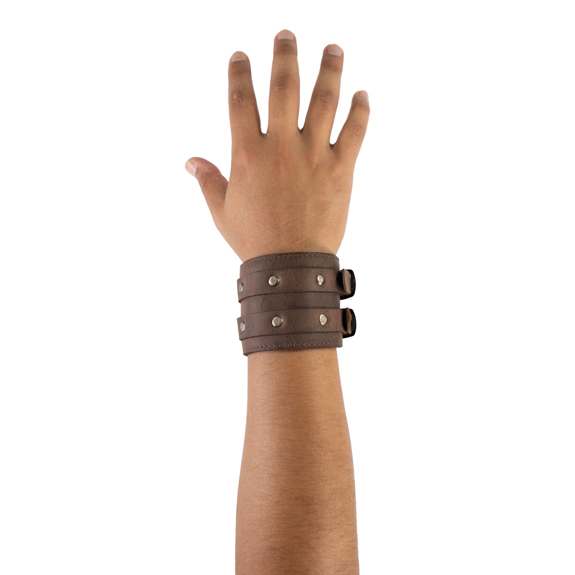 An elegant wrist model displays the Hide & Drink Wrist-Wallet-Cuff, crafted from Full Grain Leather. This rustic leather bracelet includes practical features like a hidden pouch for bills and an inner zippered pouch, showcasing functionality in style. Each piece is handmade with care in La Antigua Guatemala & Oaxaca Mexico, ensuring unique quality and artisanal beauty.