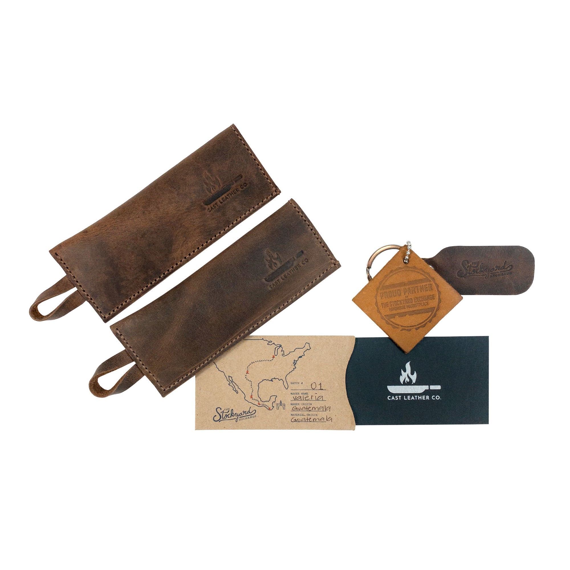 Contents of the Set of 2 Rectangular Pan Handle Covers by Cast Leather Co., including care instructions and keychain, representing full grain leather craftsmanship. These stylish kitchen accessories are handmade and fire branded, created through small batch production in La Antigua Guatemala & Oaxaca Mexico.