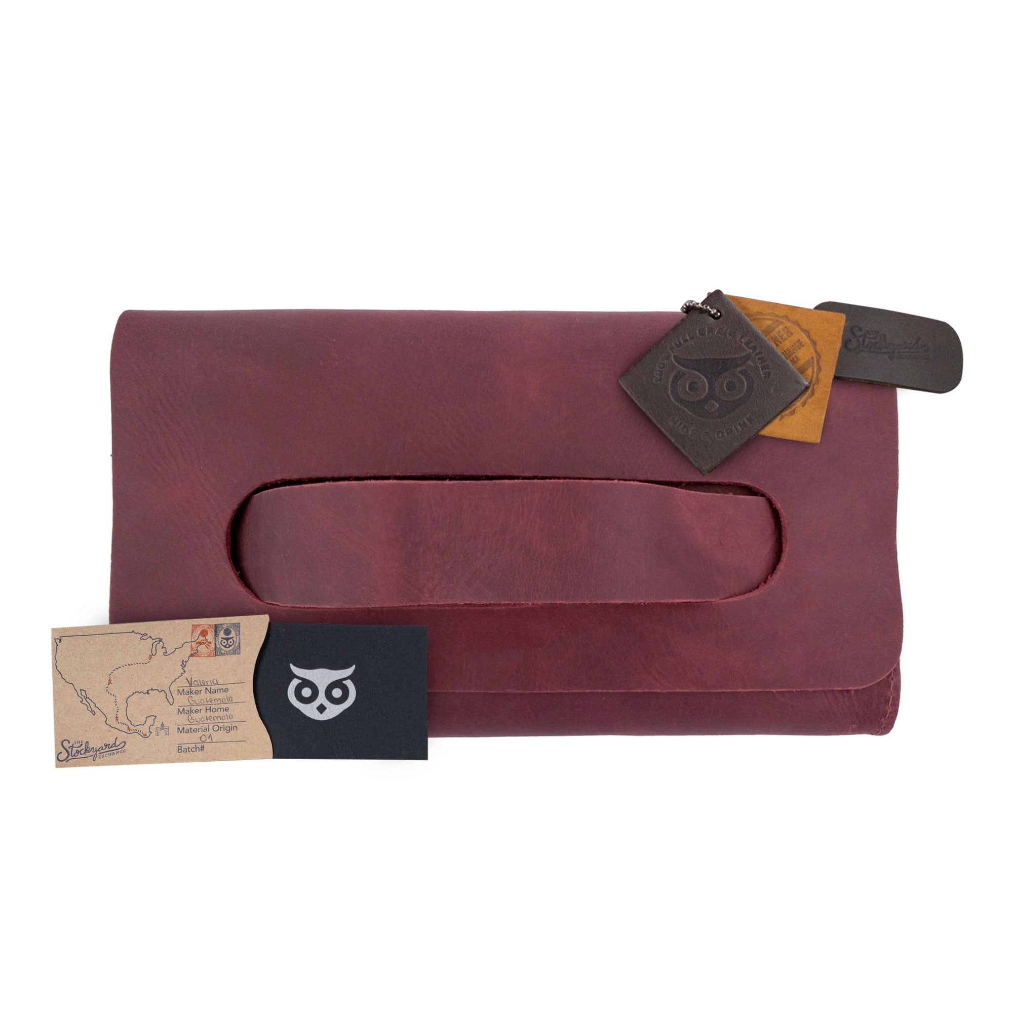 The maroon Clutch Bag With Handle from Hide & Drink, stylishly displayed with included accessories. This Full Grain Leather Clutch Bag is a fabulous gift for women, expertly handcrafted in La Antigua Guatemala & Oaxaca Mexico.