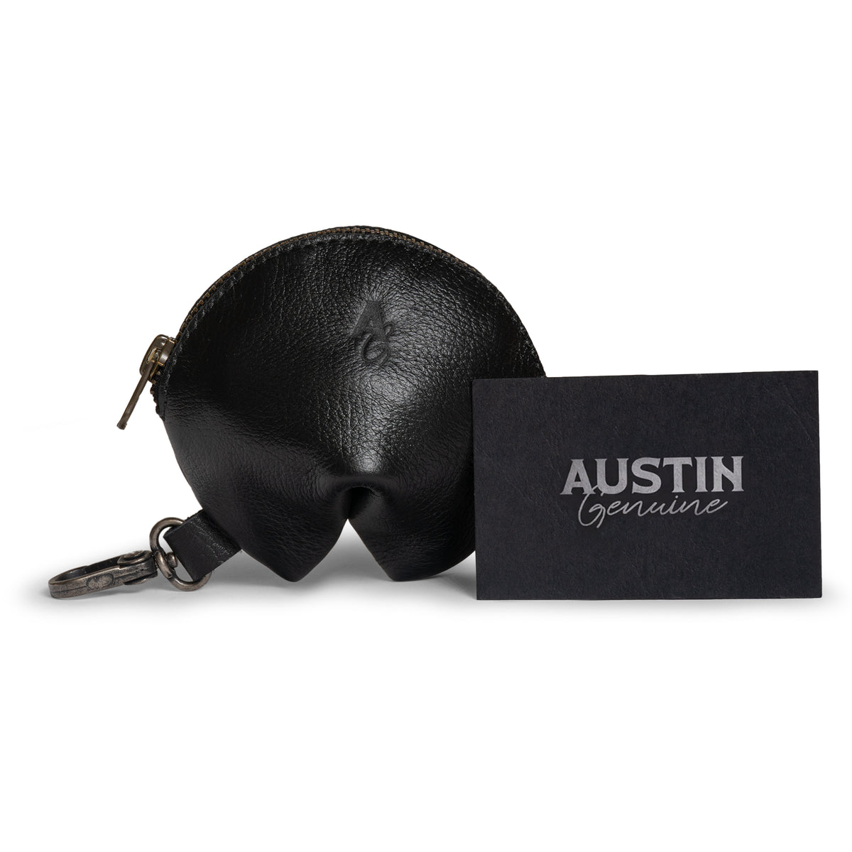 Austin Genuine The Bouldin Fortune Cookie Pouch in black Full Grain Leather displayed beside branded packaging; StockyardX Small Batch Production, Hand Cut, Hand Sewn, Fire Branded, Artisan, Handmade in La Antigua Guatemala & Oaxaca Mexico.