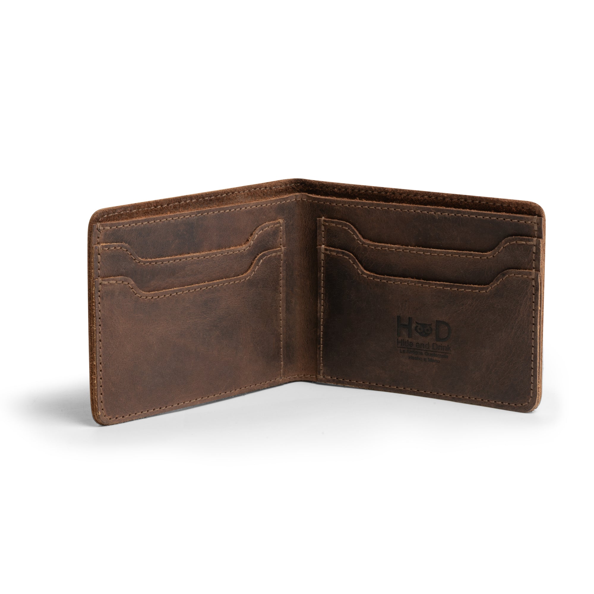 Inside view of the Classic Wallet from Hide & Drink showing multiple card slots, perfect for organization. This Classic Bifold Wallet is handcrafted from Full Grain Leather, making it a durable storage case for identification. Ideal as a travel accessory, this artisan-made wallet features small batch production techniques. Hand cut and hand sewn in La Antigua Guatemala & Oaxaca Mexico.