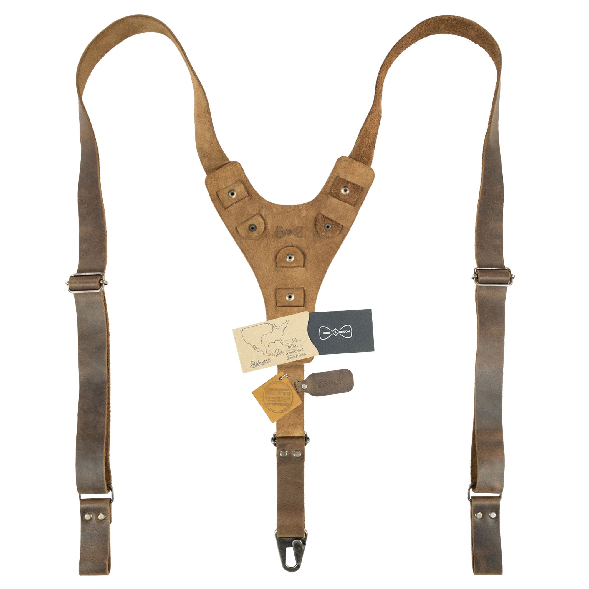 Rustic Y Back Suspenders from Hide & Groom, displayed with craftsmanship tags and brand details. These full grain leather suspenders, ideal for groomsmen and best men, are handmade in La Antigua Guatemala, showcasing artisan techniques perfect for wedding ceremonies and dinner parties.