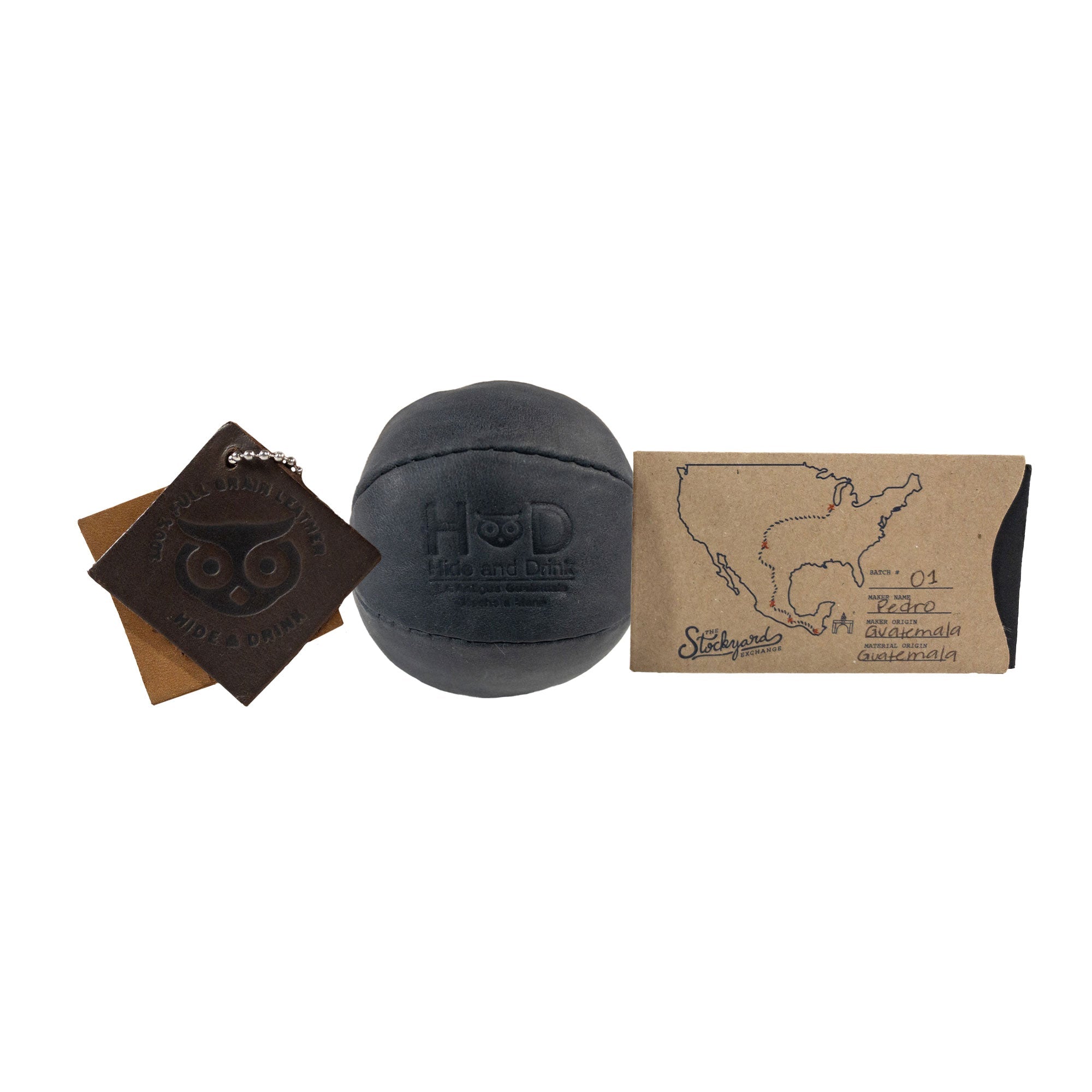 Hide & Drink black Stress Ball with packaging, signifying its quality as a gift option. This squishy tension accessory is great for relieving fidgeting and anxiety, made with full grain leather artisan crafted in La Antigua Guatemala.