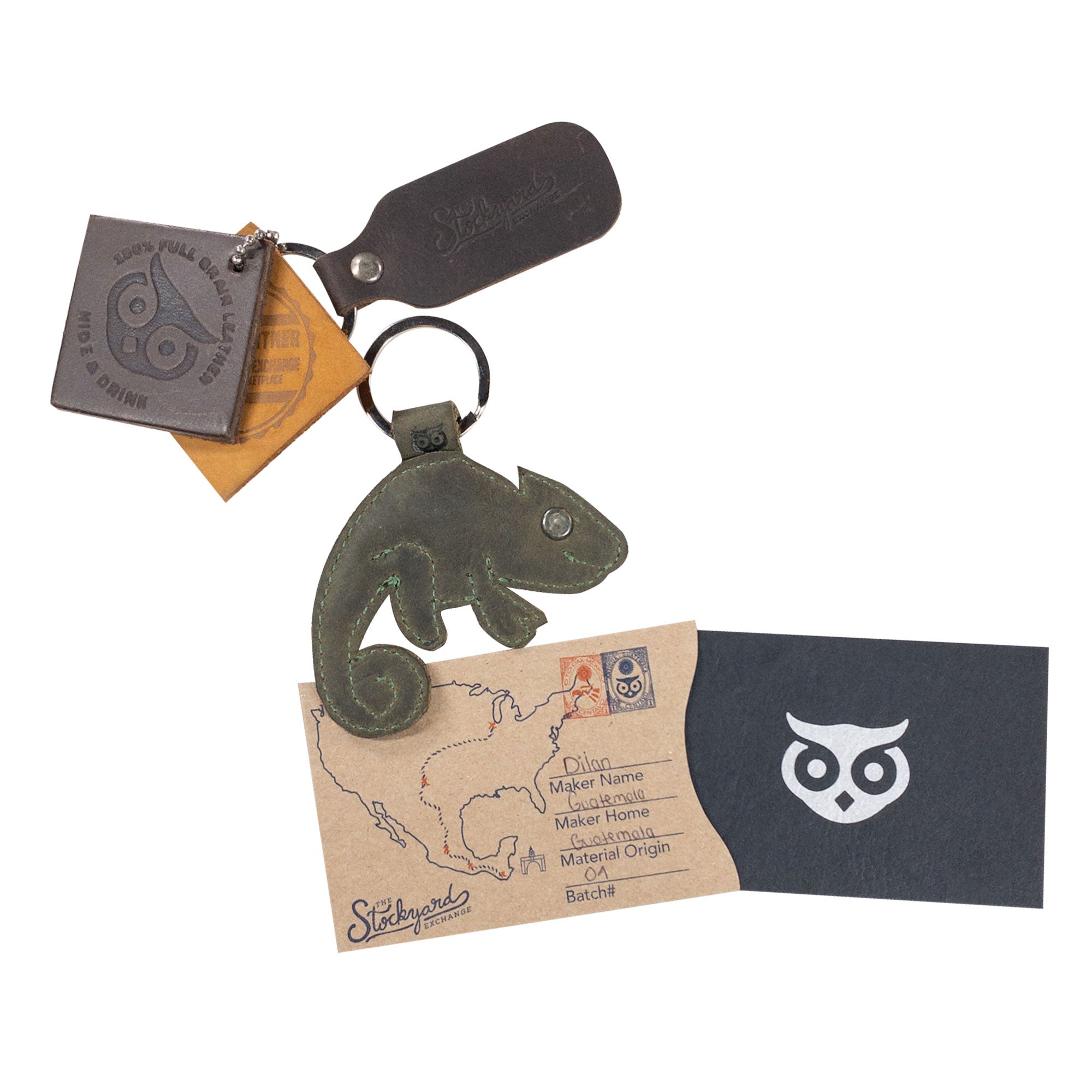 Hide & Drink's Chameleon Keychain alongside care instructions and branding tags, exemplifying full grain leather craftsmanship. This small batch, handmade key holder caters to wildlife enthusiasts, combining style and durability, all made in La Antigua Guatemala & Oaxaca Mexico.
