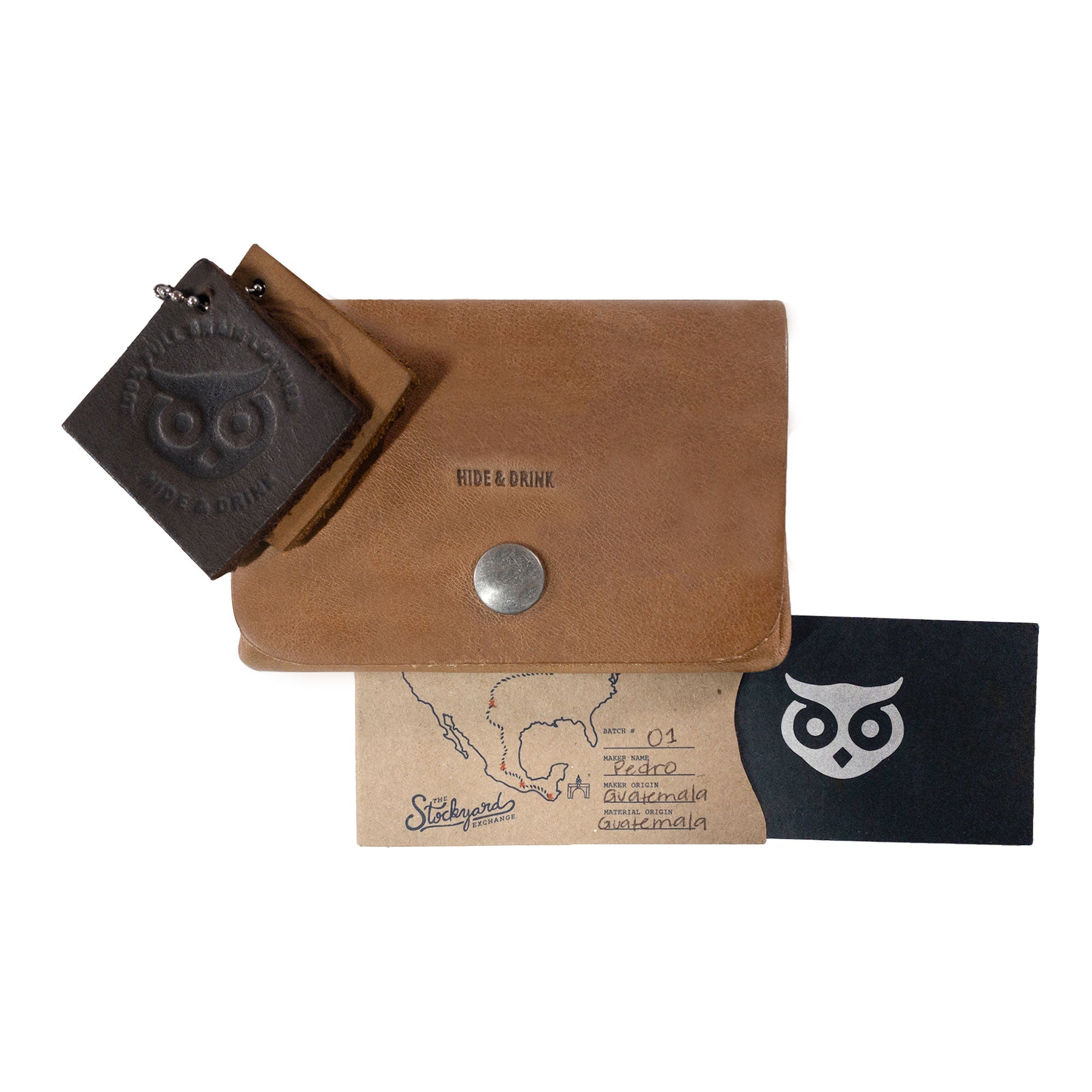 Display of the brown Double Pouch Card Wallet by Hide & Drink alongside various leather items. This practical Leather Double Pouch Card Wallet is excellent as a card organizer, cash holder, and ID case, ideal for both men and women, made from Full Grain Leather in La Antigua Guatemala & Oaxaca Mexico.