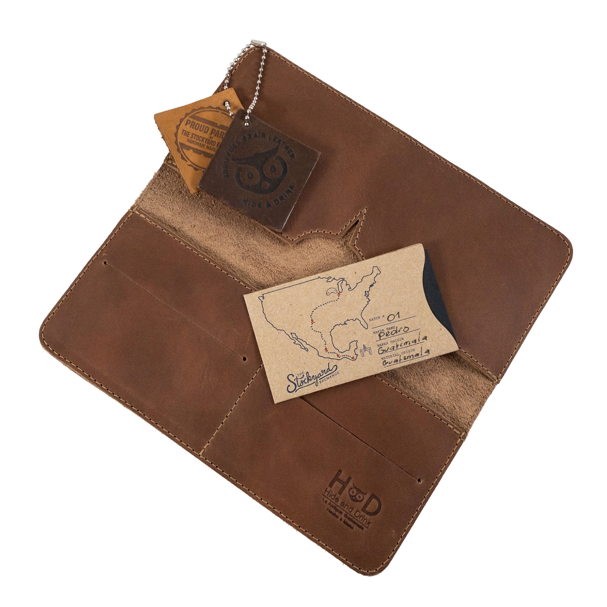 Open vintage bifold wallet for cellphone by Hide & Drink, highlighting card and cash compartments. This Bifold Wallet for Cellphone features durable Full Grain Leather for style and practicality. Experience the high-quality artisan craftsmanship achieved through small batch production in La Antigua Guatemala & Oaxaca Mexico.
