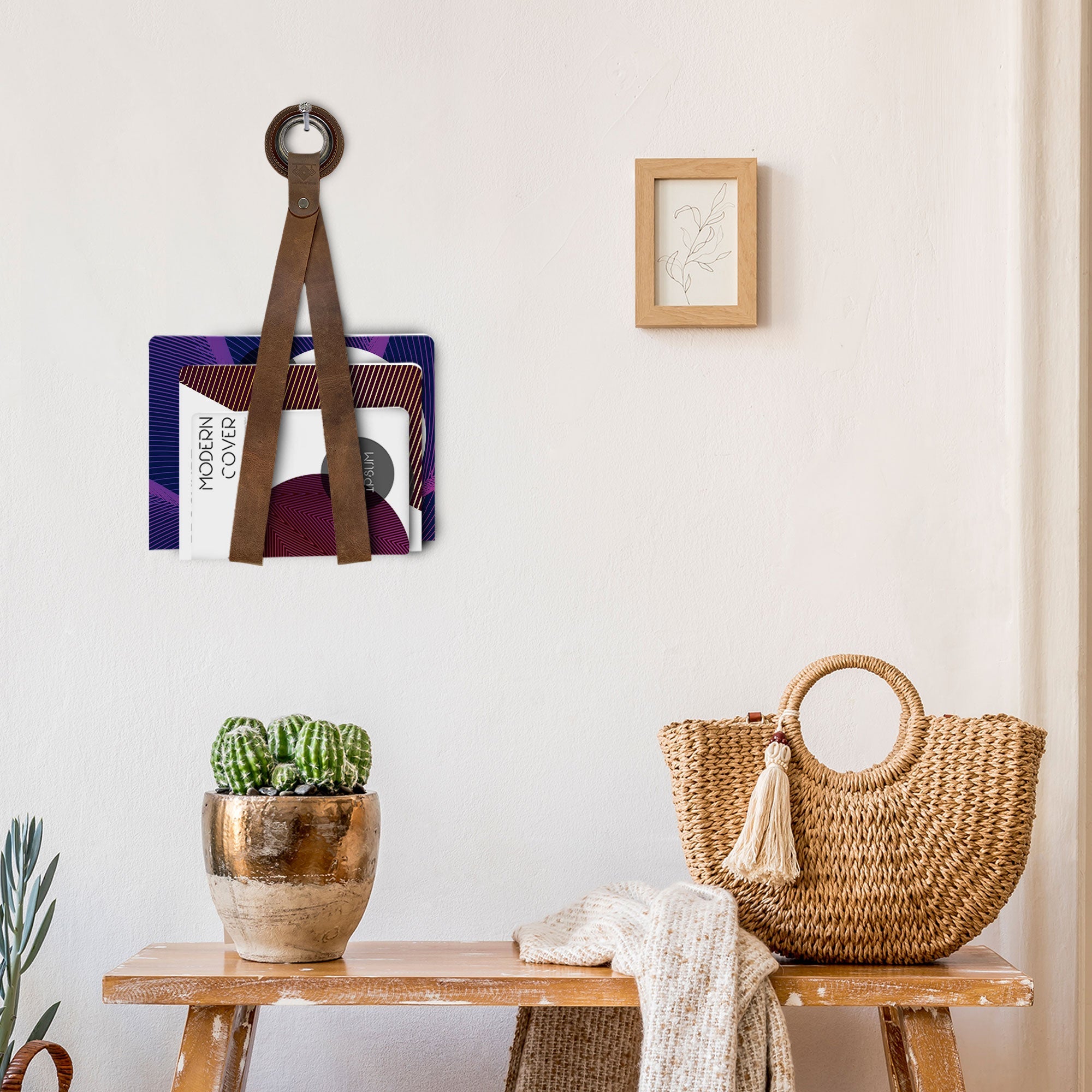 An elegant Book Wall Hanger displayed in a chic setting, perfect for book lovers. This rustic book organizer by Leather At Home is made from high-quality full grain leather and adds character to any wall while keeping your reading essentials organized. Artisan crafted in La Antigua Guatemala & Oaxaca Mexico, it showcases hand cut and hand sewn details.