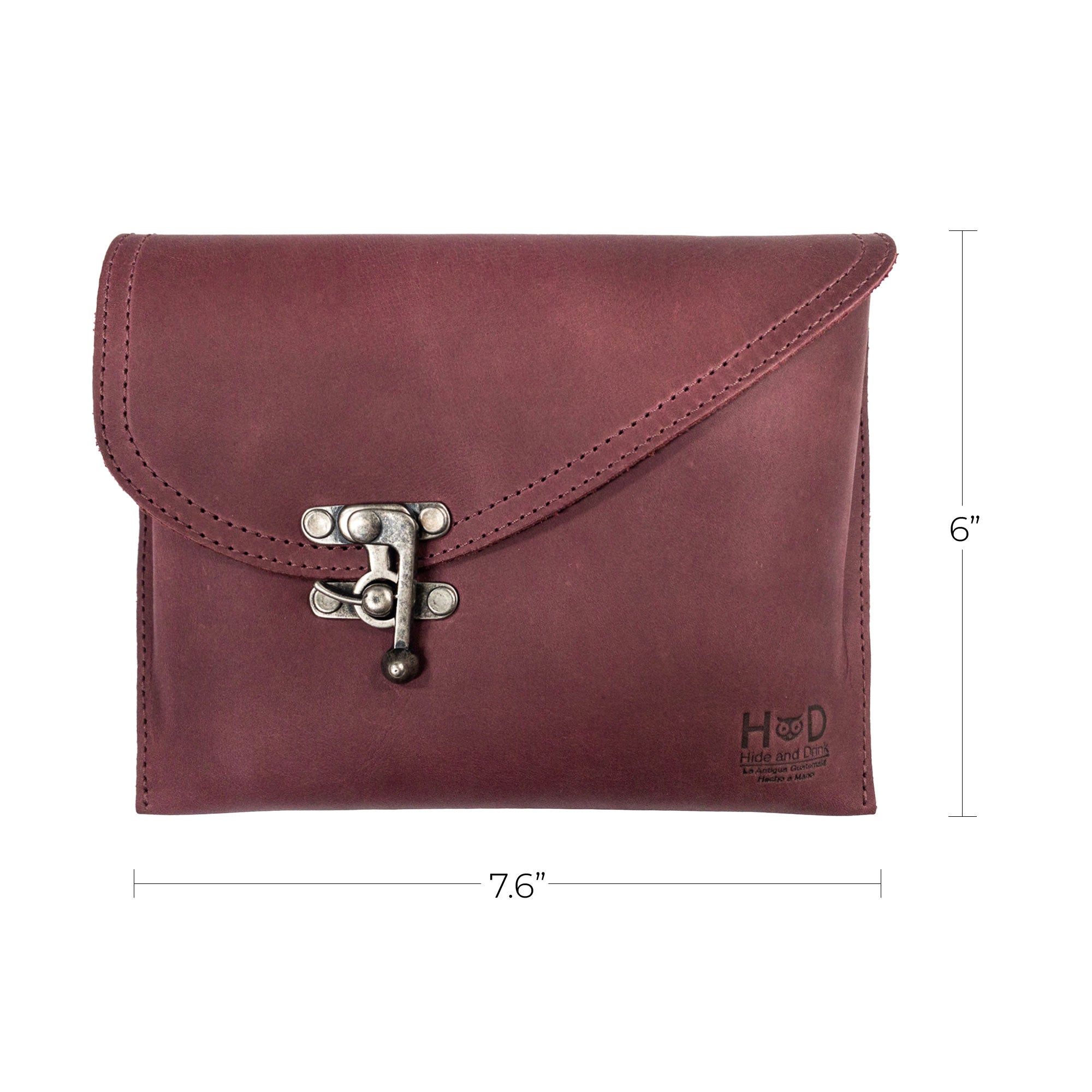 Dimensions of the Petite Vintage Clutch Bag by Hide & Drink being shown, size 7.6" x 6". This handcrafted handbag, made from full grain leather, makes the perfect evening bag or travel accessory. Each piece is hand cut, hand sewn, and artisan made in La Antigua Guatemala & Oaxaca Mexico.