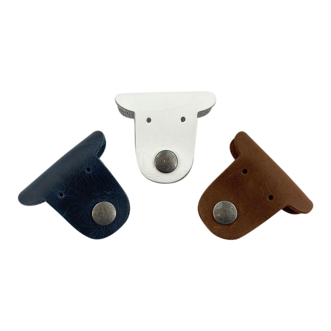 Multicolor Dog Cord Keeper (3 Pack) by Taco Dog featuring three adorable dog-shaped cord organizers in navy, white, and brown leather. Dog Cord Keeper - Wrap Up Your Cables, Earbuds, Headphones, Chargers - Clip The Straps Together for Easy Management and Travel - 3-Pack, Full Grain Leather, StockyardX, Small Batch Production, Hand Cut, Hand Sewn, Fire Branded, Artisan, Handmade in La Antigua Guatemala & Oaxaca Mexico.