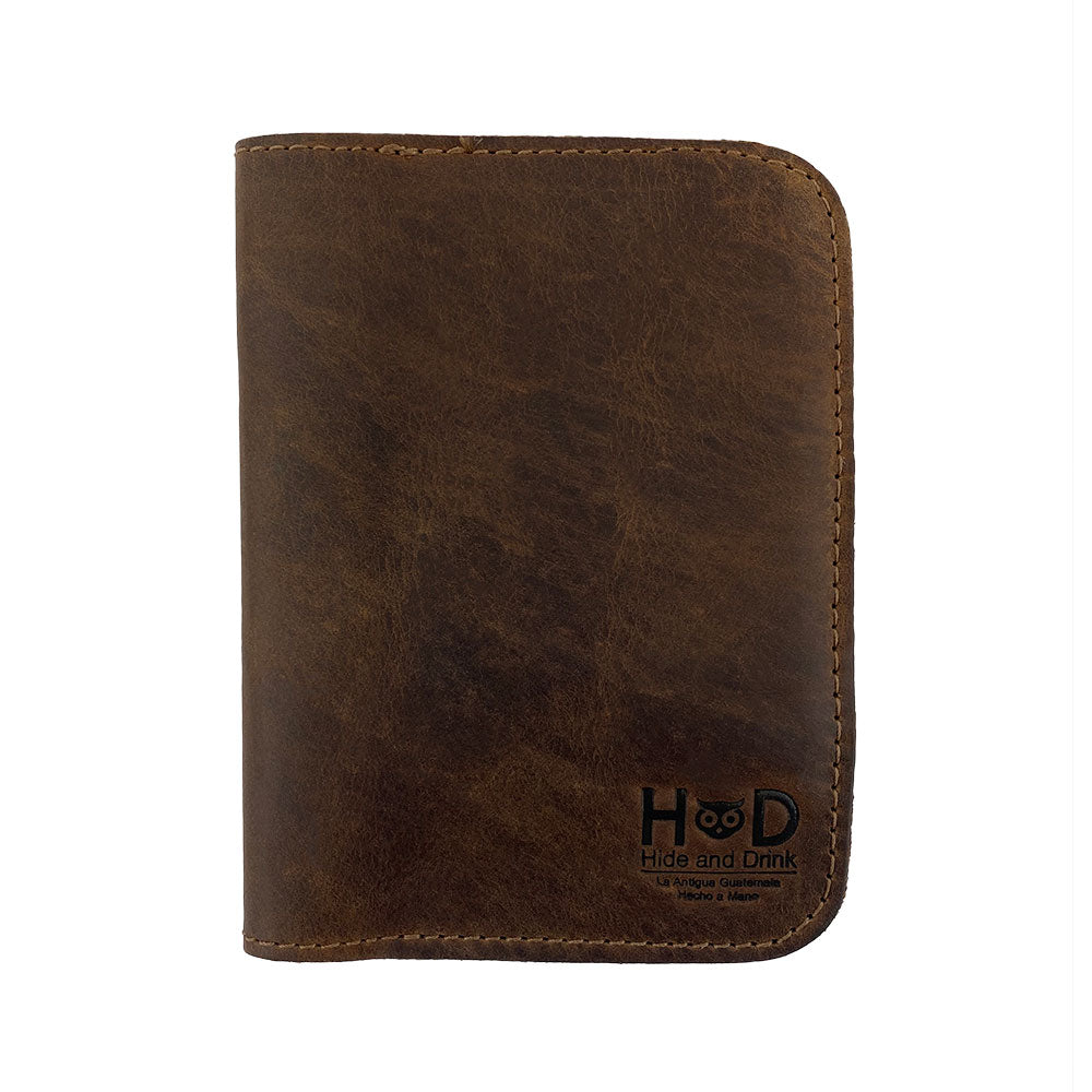 Back view of another color variation of the Hide & Drink Travel Wallet, showcasing its craftsmanship. This leather travel wallet serves as a bifold passport case and card holder, artisan-made in La Antigua Guatemala.