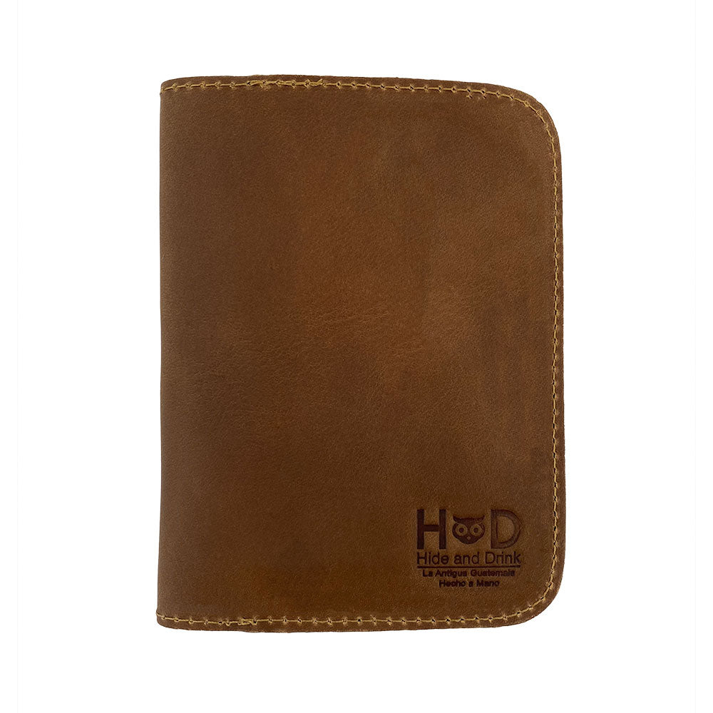 Front view of a new color option of the Hide & Drink Travel Wallet, showing the smooth leather finish. This handcrafted wallet acts as a stylish travel wallet and classic bifold passport case, made in La Antigua Guatemala.